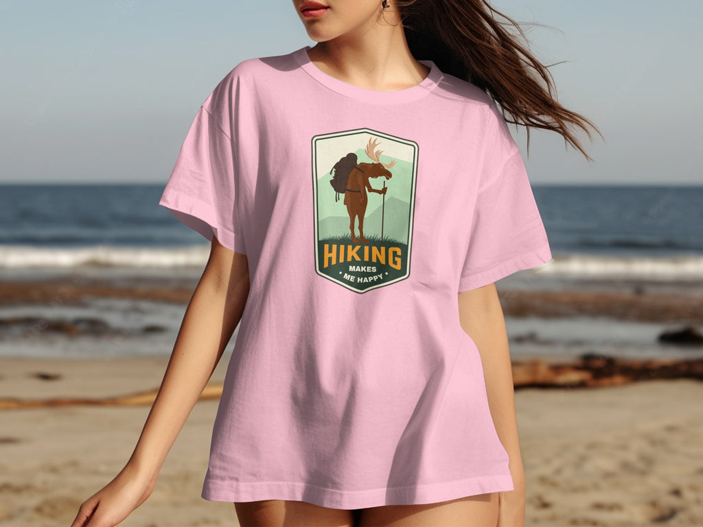 Pink t-shirt with a moose hiking graphic and text "Hiking Makes Me Happy".