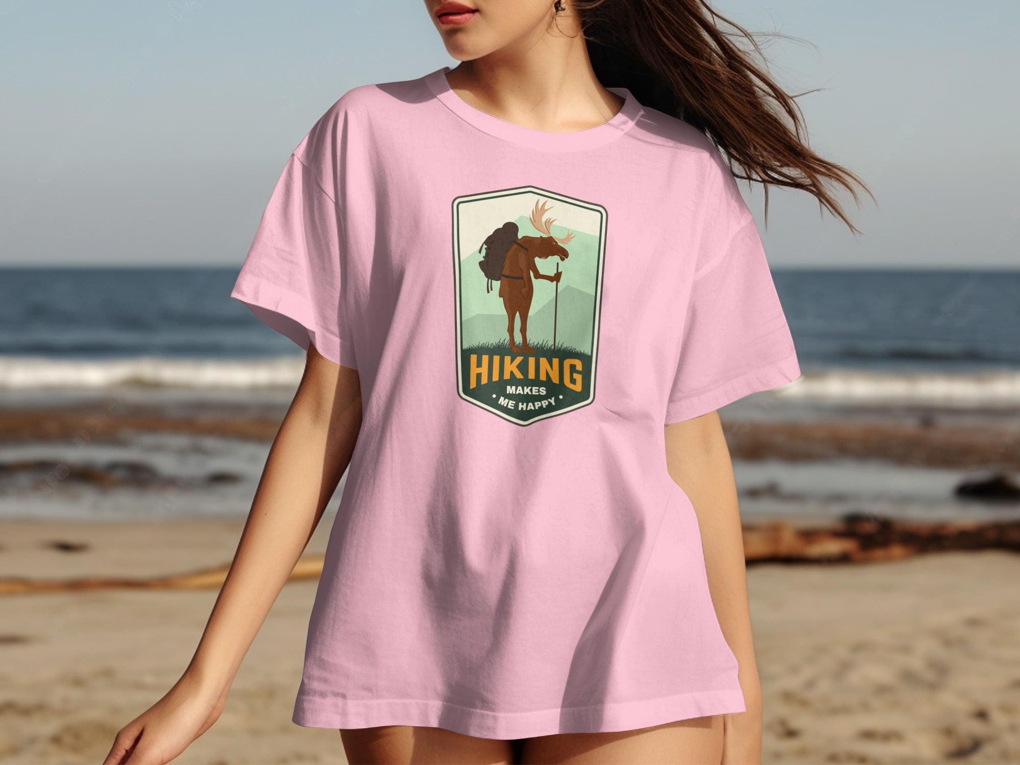 Pink t-shirt with a moose hiking graphic and text "Hiking Makes Me Happy".