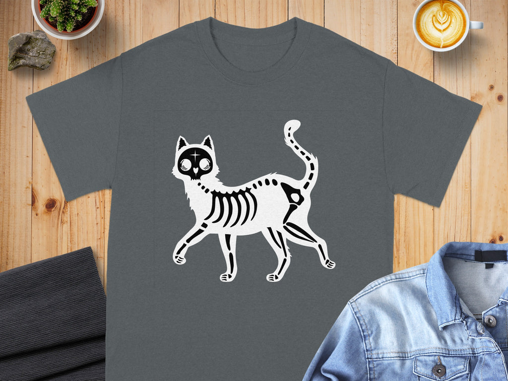 T-shirt with a black and white skeleton cat graphic on a wooden background.
