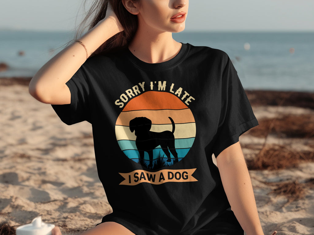 Black t-shirt with vintage sunset circle graphic, dog silhouette, and text "Sorry I'm Late I Saw a Dog".