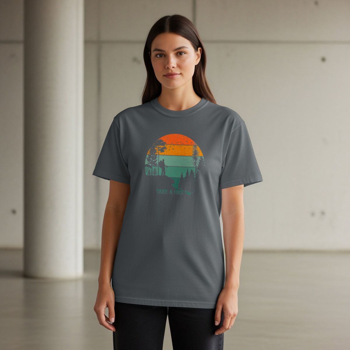 T-shirt with a vintage sunset graphic featuring hikers and trees. Text reads "TAKE A HIKE".