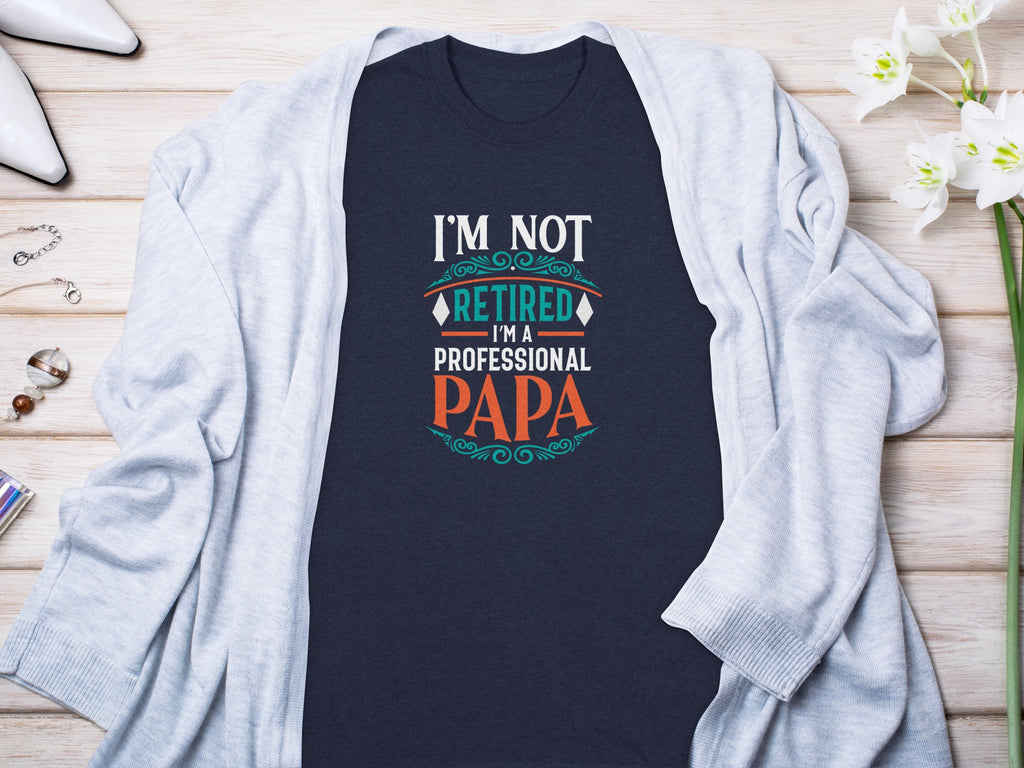 Dark blue t-shirt with "I'M NOT RETIRED I'M A PROFESSIONAL PAPA" text.