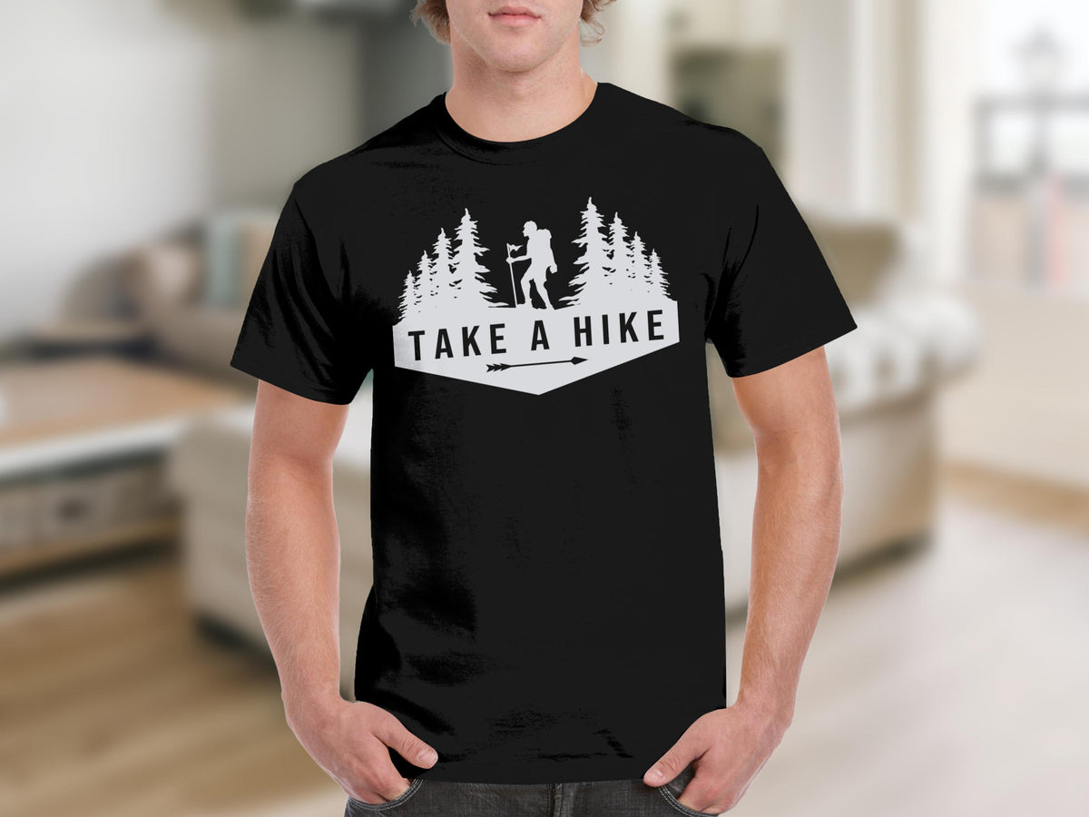 Black t-shirt with white graphic of hiker and trees, text reads "TAKE A HIKE".
