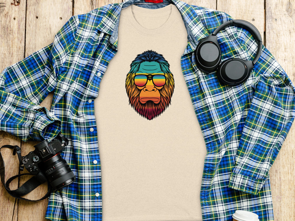 Beige t-shirt with a colorful ape graphic wearing sunglasses.