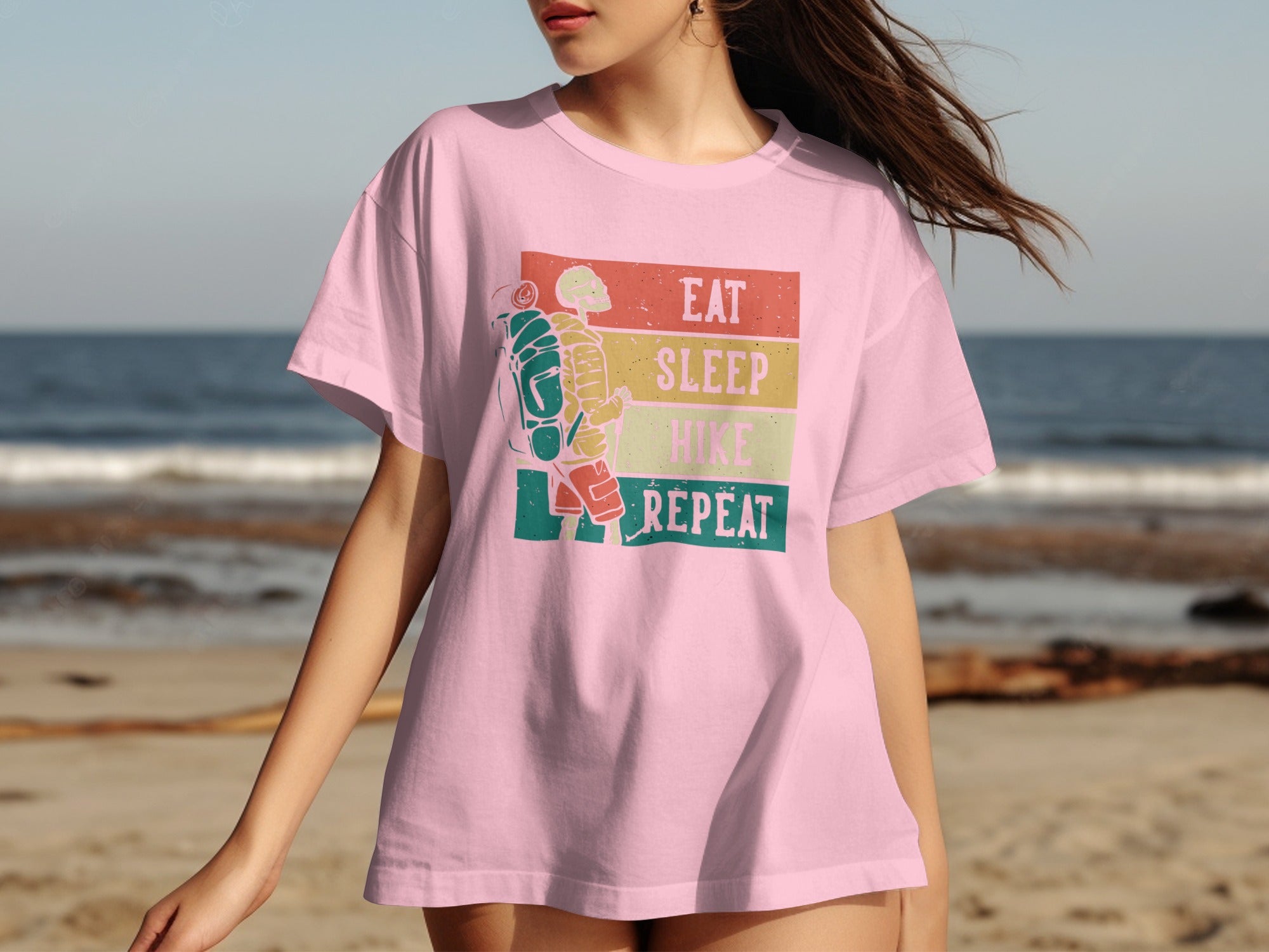 Pink t-shirt with "Eat Sleep Hike Repeat" text and hiking skeleton graphic.