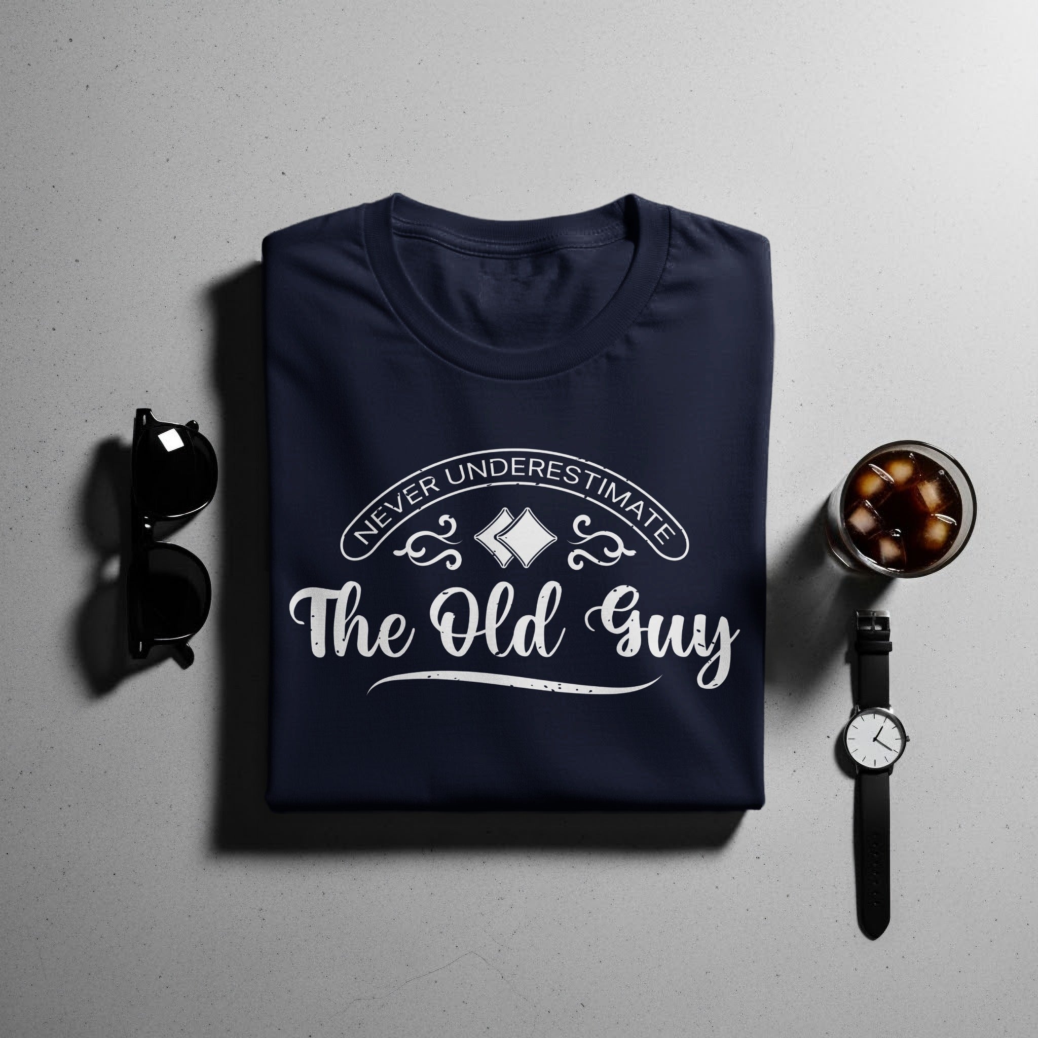 Navy t-shirt with white text "NEVER UNDERESTIMATE The Old Guy".