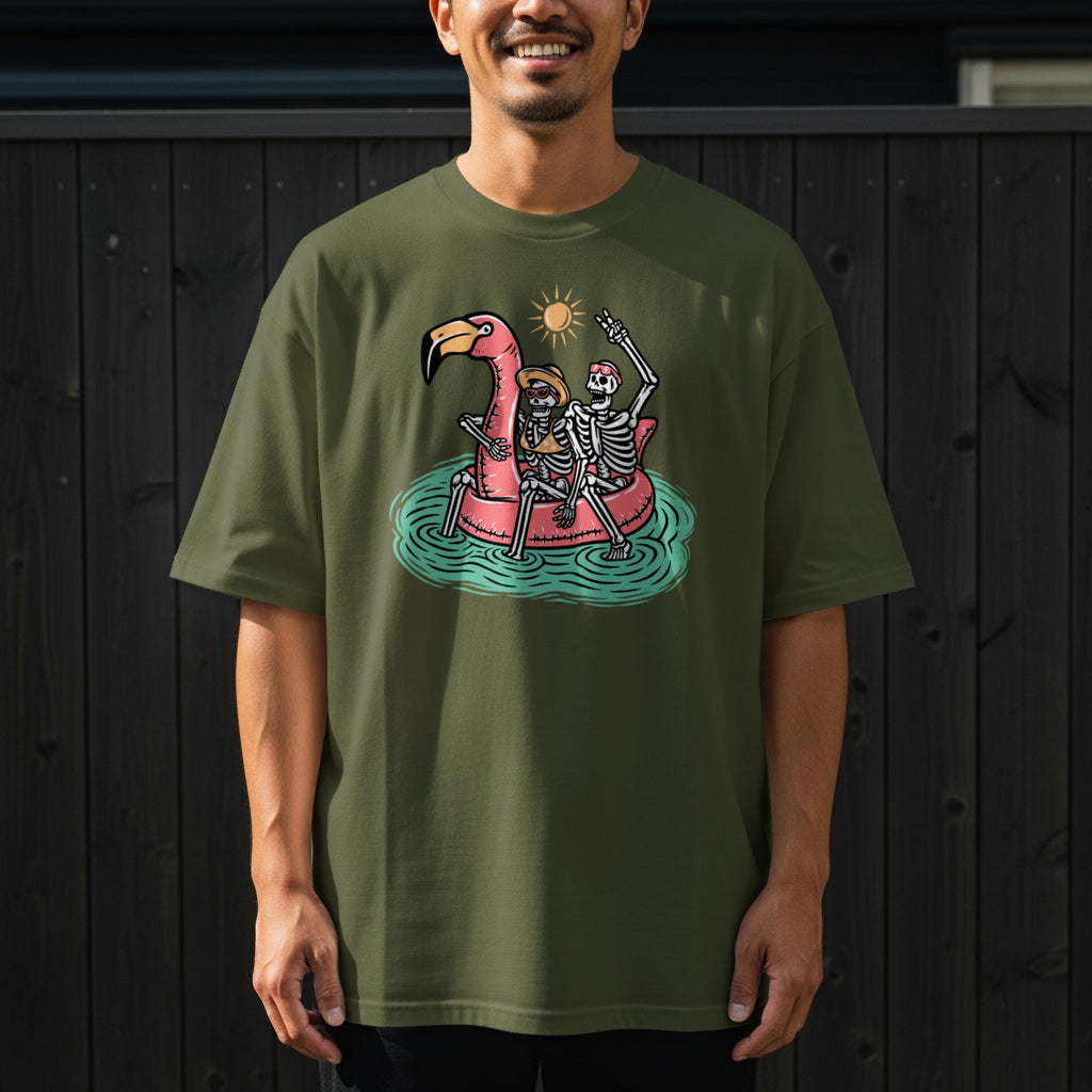 Skeletons in a flamingo float with a sun and water graphic on a green t-shirt.