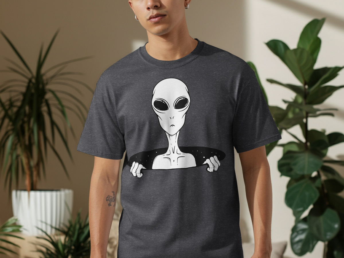 Dark grey t-shirt with a white alien graphic emerging from a black hole.