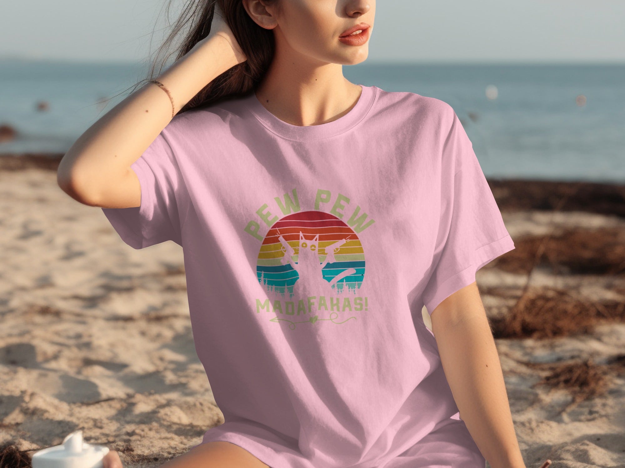 Pink t-shirt with a cat shooting guns graphic and "Pew Pew Madafahas!" text.