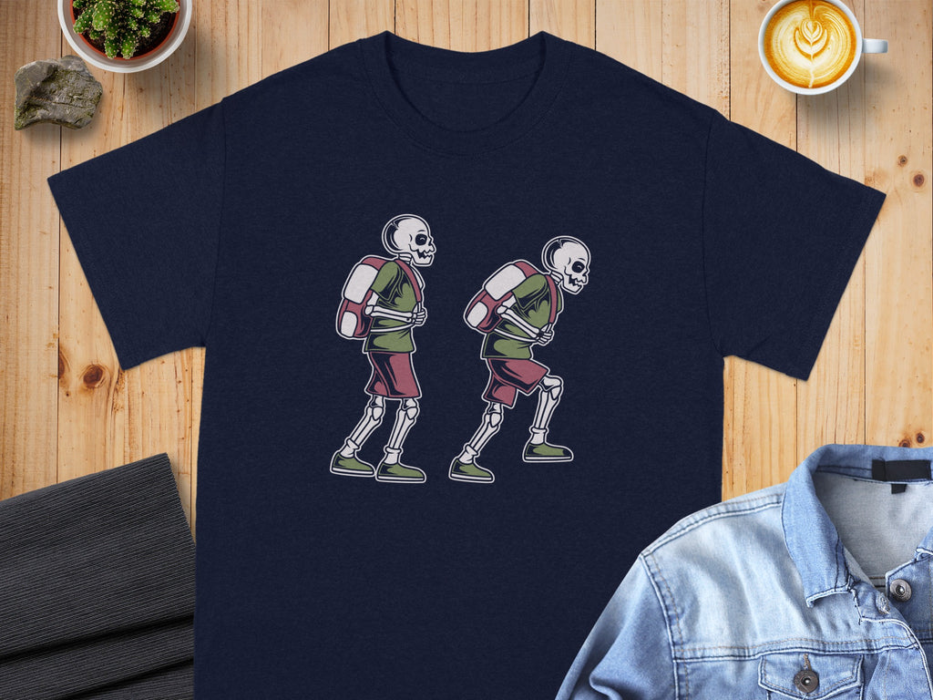 Dark blue t-shirt with skeletons wearing backpacks and shorts graphic.