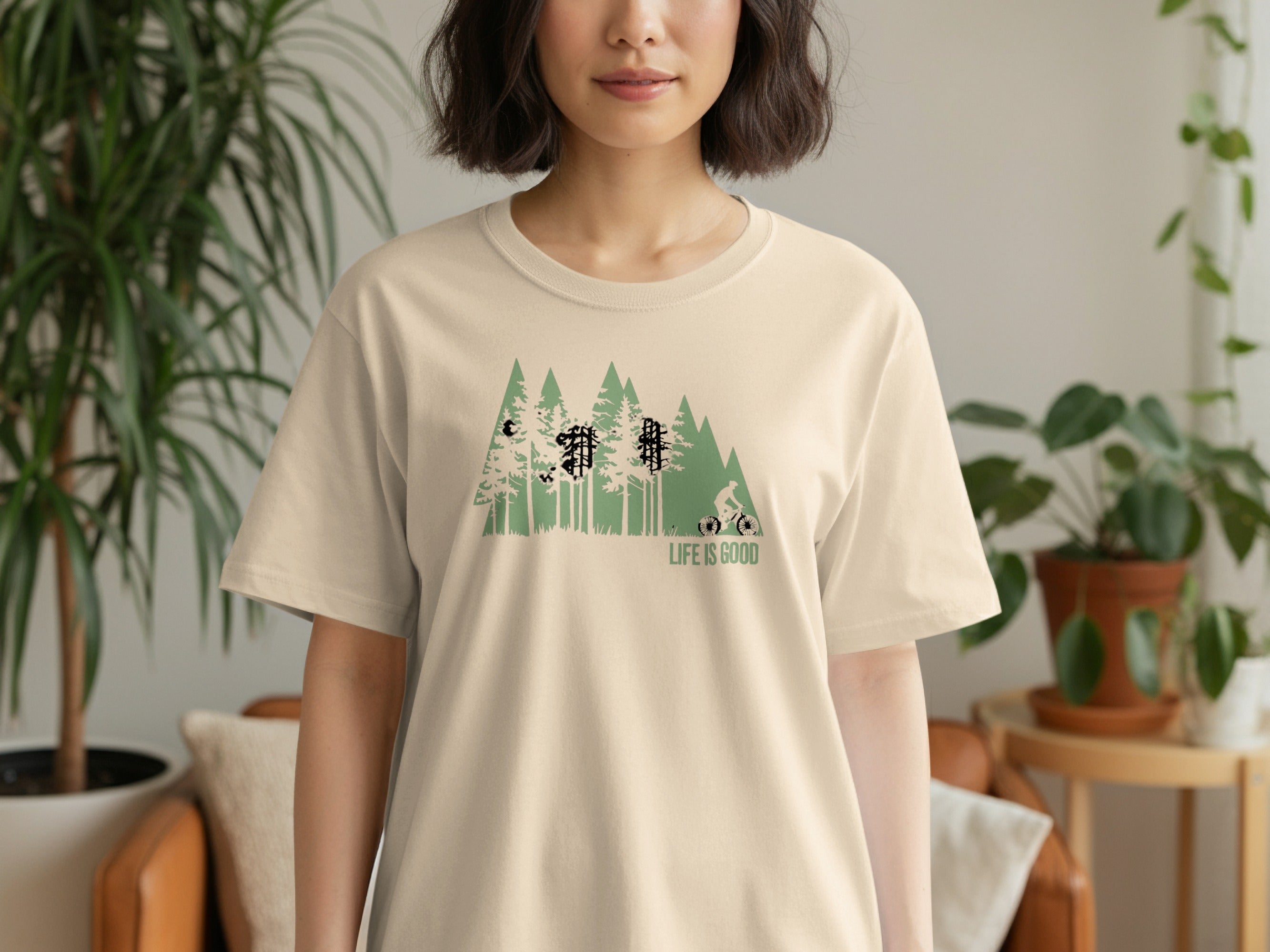 T-shirt with green forest graphic and text "LIFE IS GOOD"