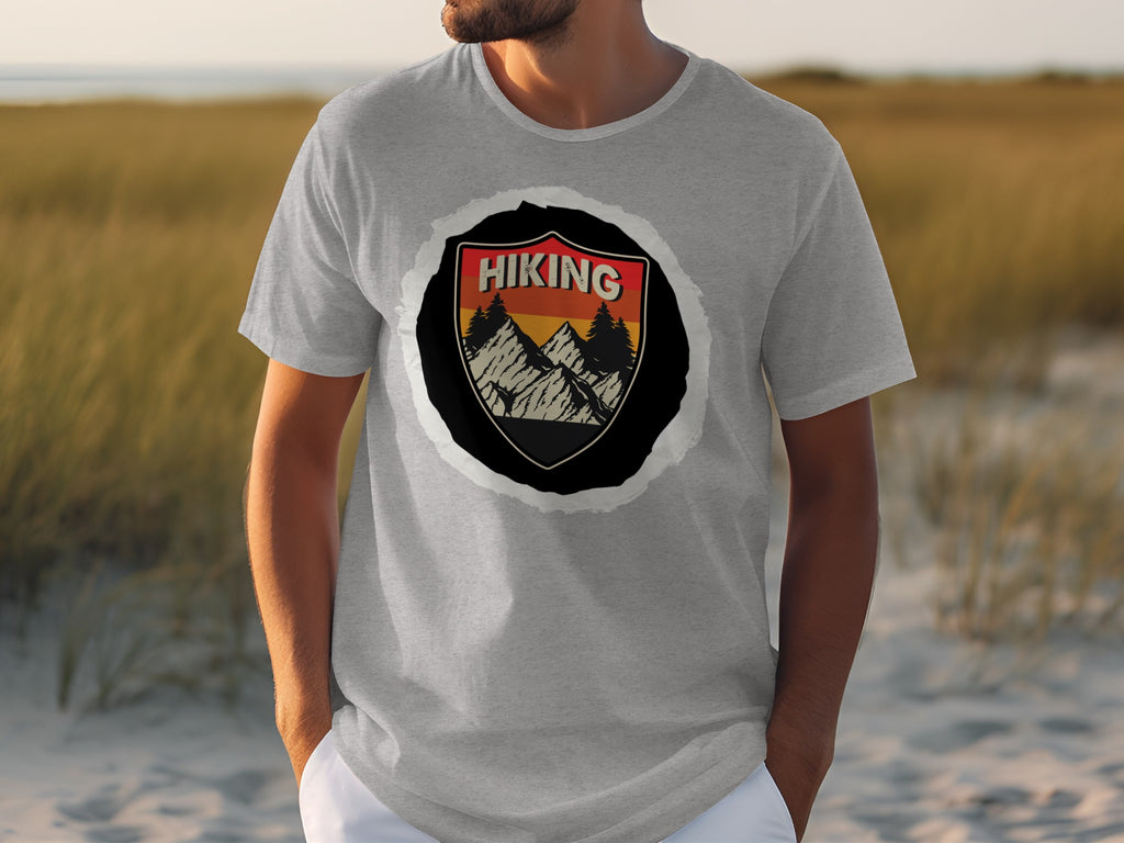 Gray t-shirt with a black shield graphic featuring "HIKING" text, mountains, and trees.
