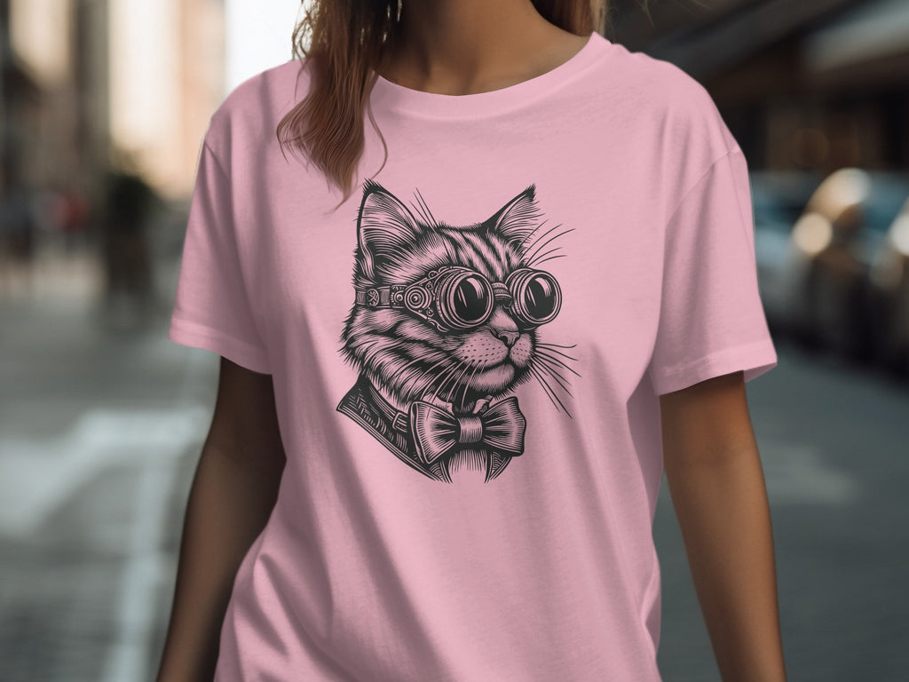 Black and white drawing of a cat wearing goggles and a bowtie on a pink t-shirt.