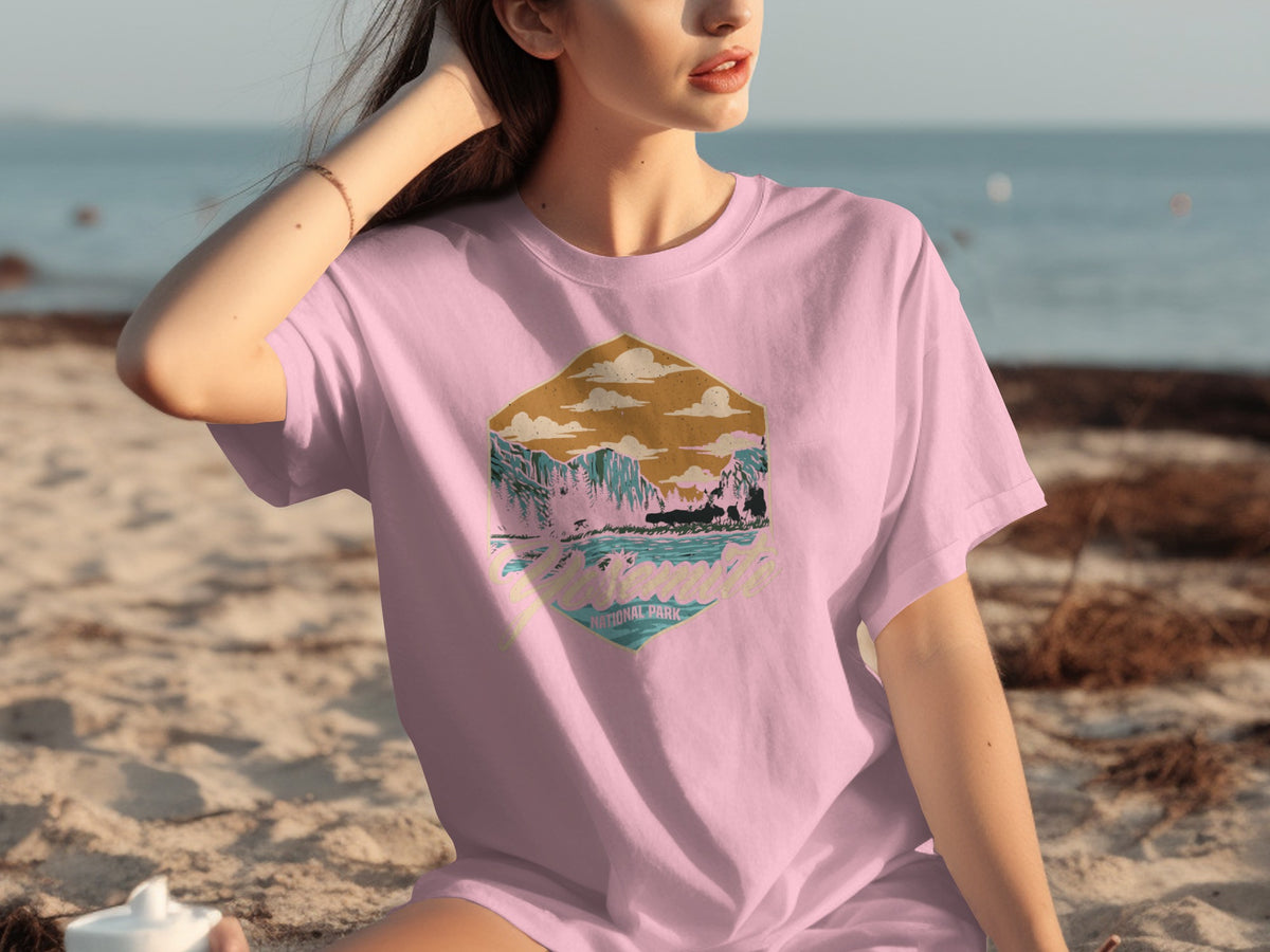 Pink t-shirt with Yosemite National Park graphic featuring mountains, water, and clouds.