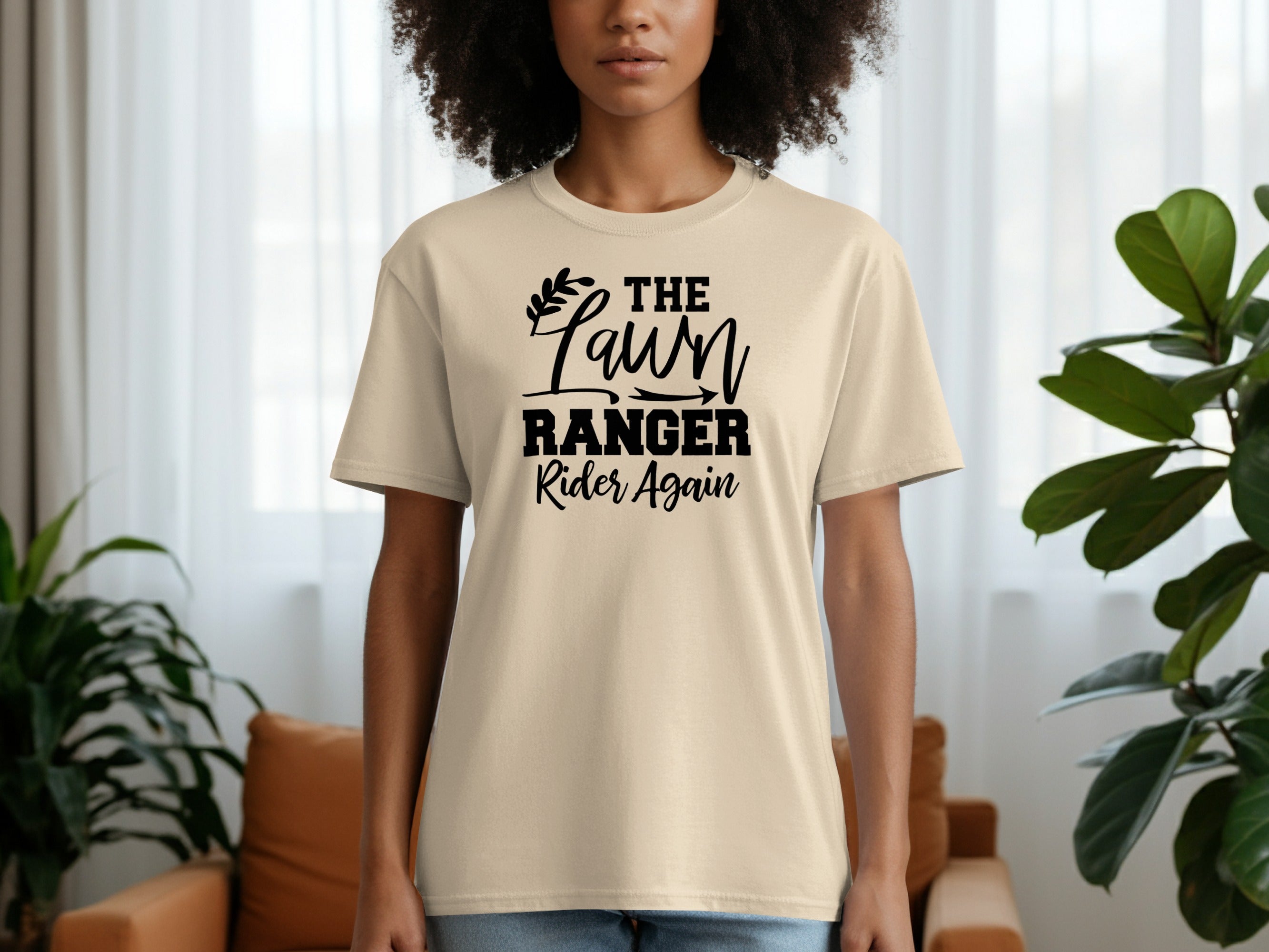 Light beige t-shirt with black text saying "THE LAWN RANGER Rider Again".