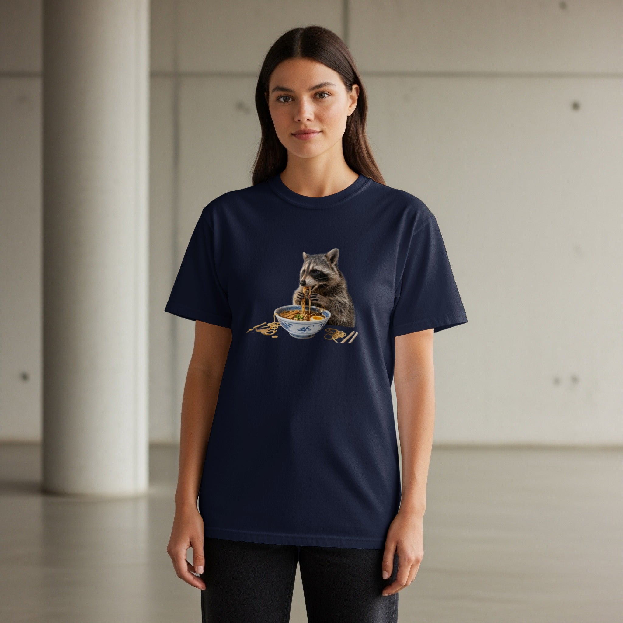 Navy t-shirt with a graphic of a raccoon eating ramen noodles.