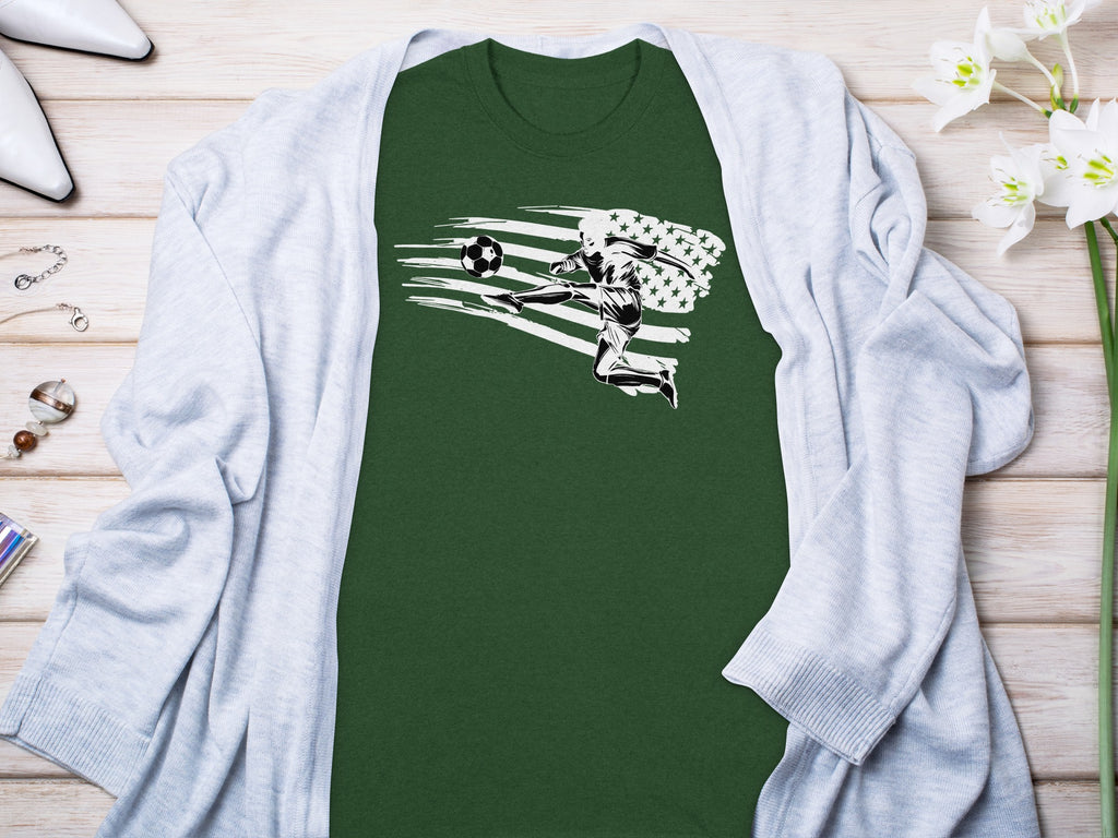 Green t-shirt with soccer player kicking ball against distressed American flag graphic.