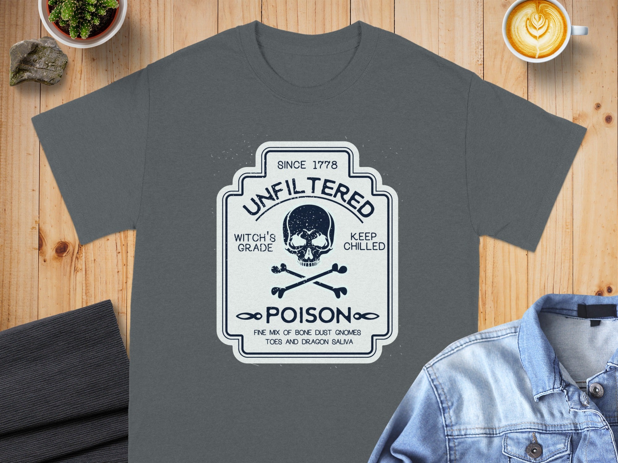 Dark gray t-shirt with a distressed label graphic featuring a skull, crossbones, and "Poison" text.