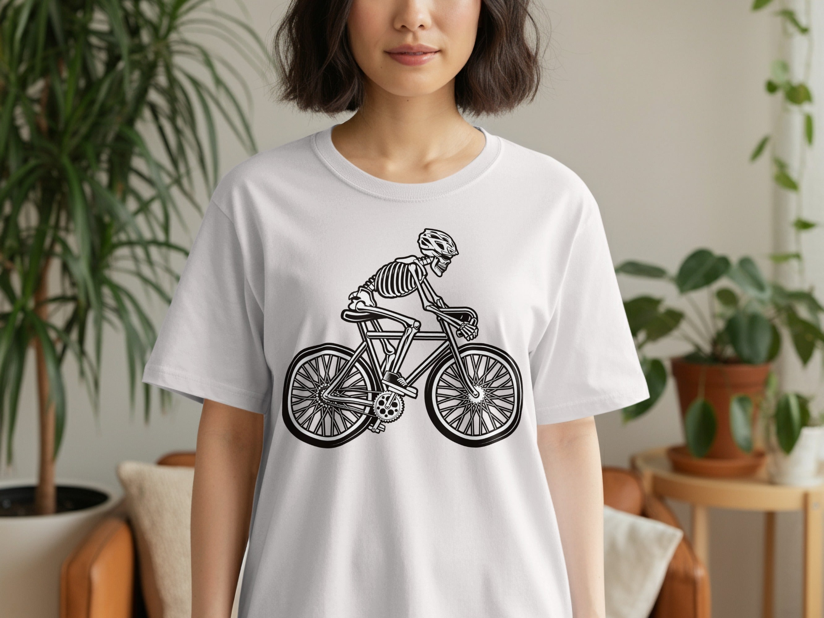 Skeleton cyclist graphic on a white t-shirt.