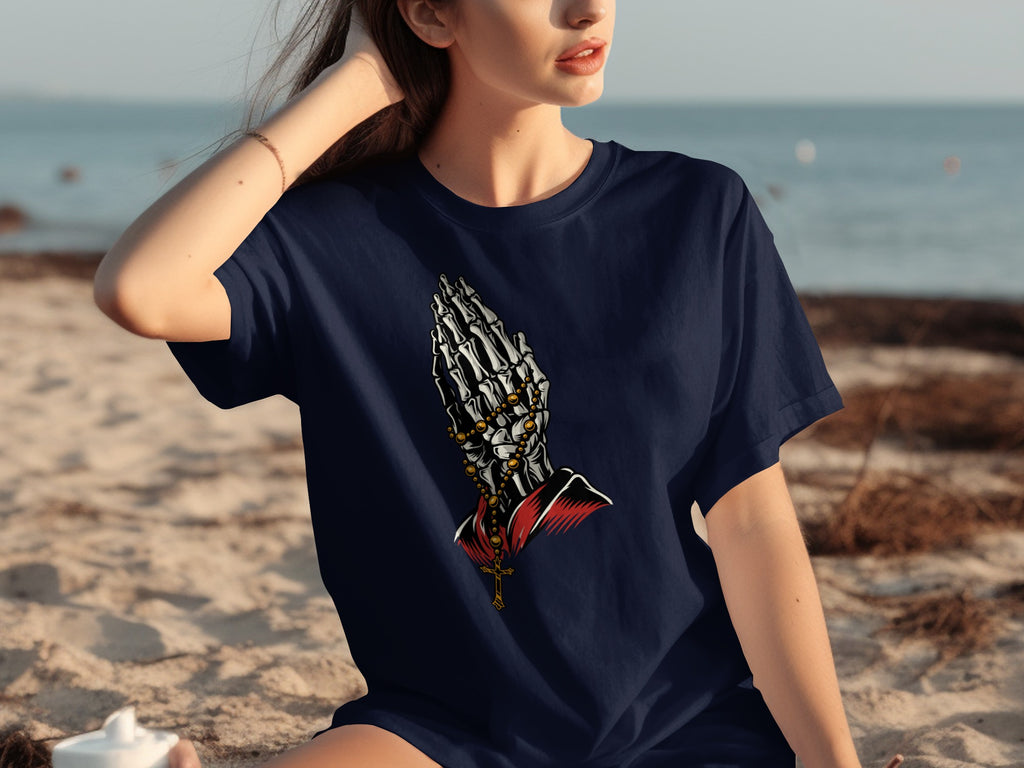 Navy t-shirt with skeleton praying hands graphic and cross necklace.