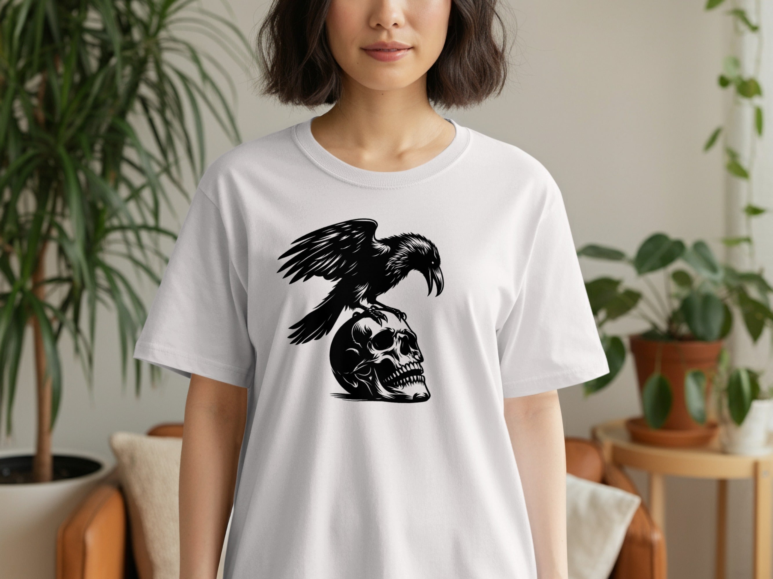 White t-shirt with a black crow perched on a skull graphic.