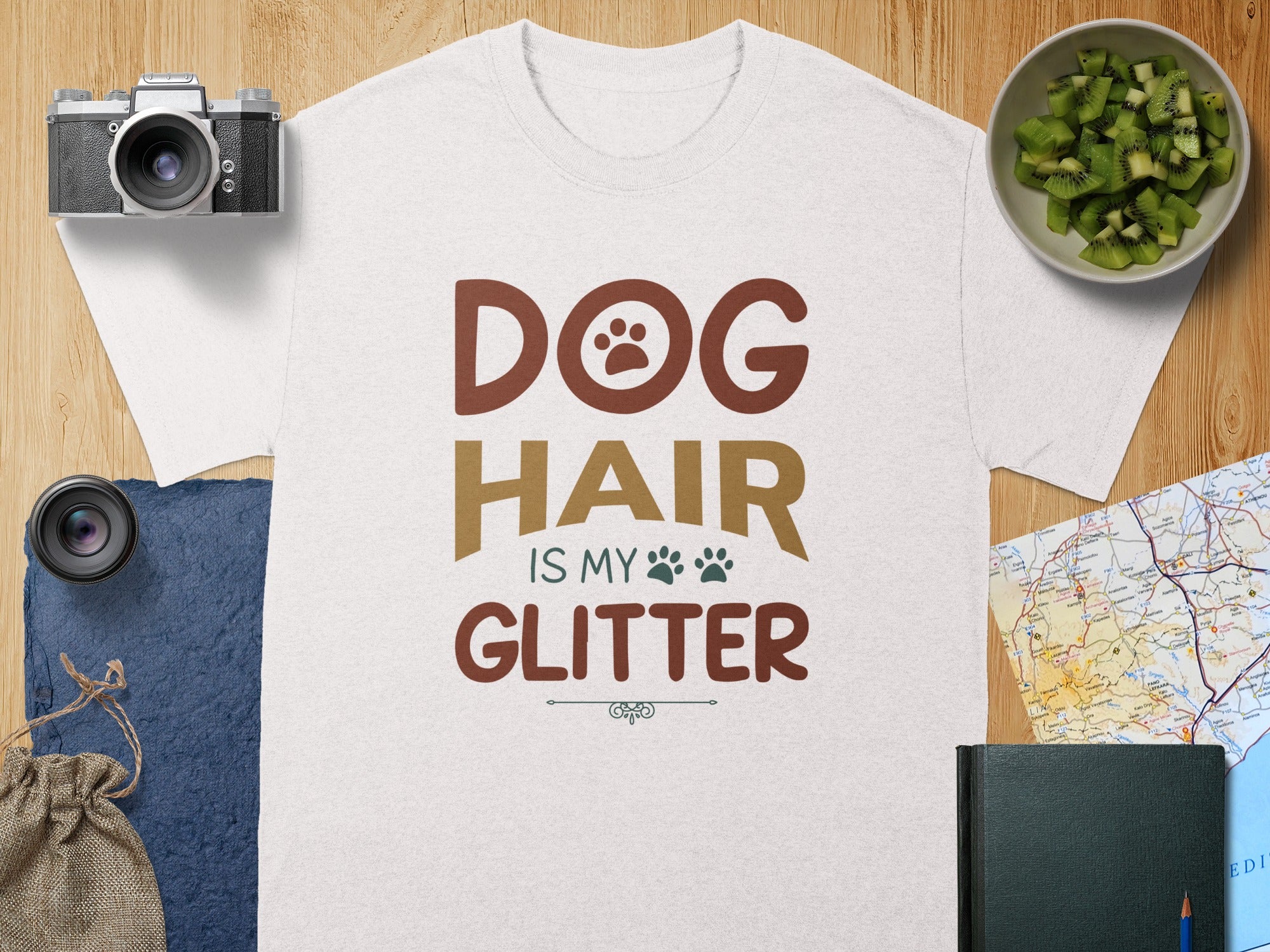 White t-shirt with "DOG HAIR IS MY GLITTER" text and paw print.