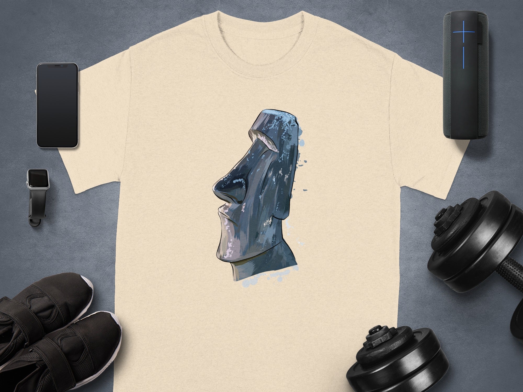 Cream t-shirt with Moai statue watercolor graphic, displayed with accessories.