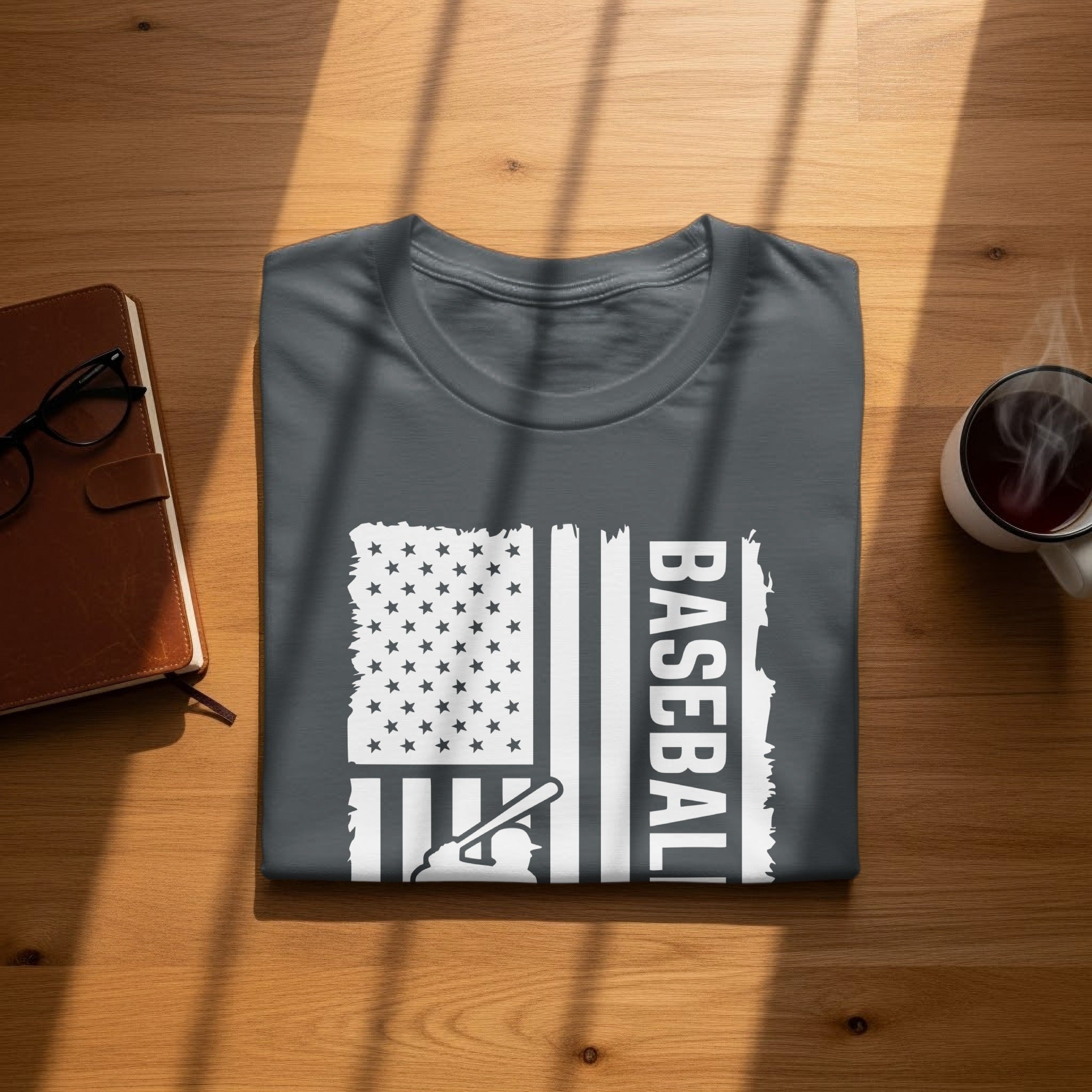 Dark grey t-shirt with white distressed US flag graphic featuring "BASEBALL" and baseball player silhouette.