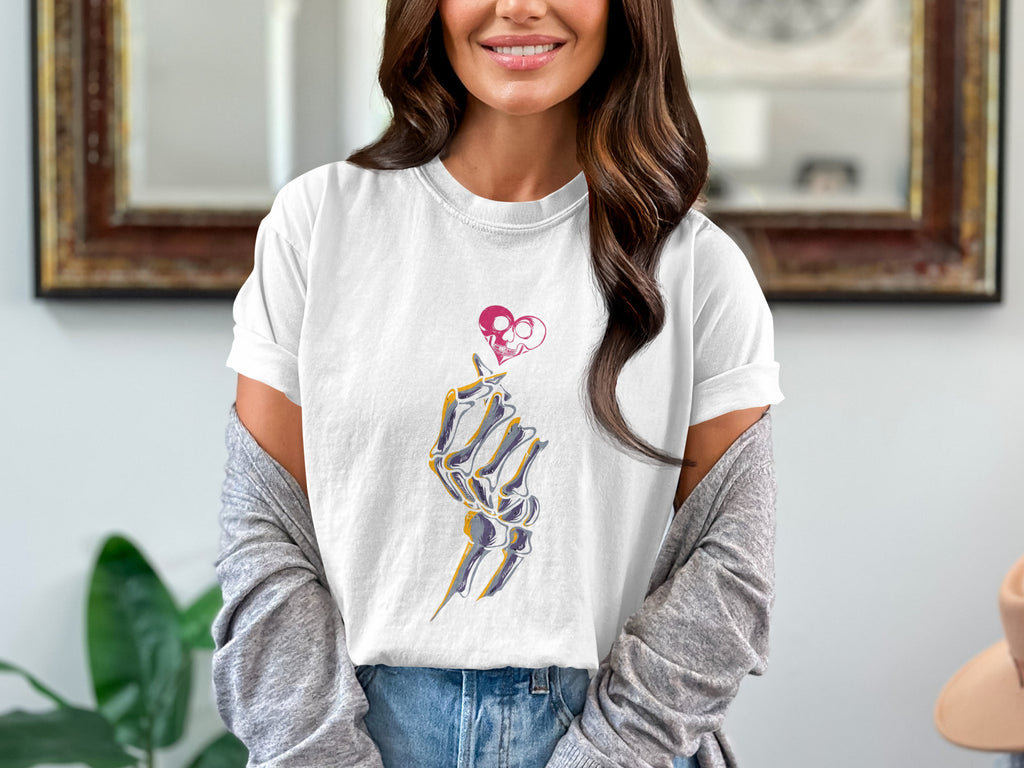 White t-shirt with skeleton hand forming a heart shape with a skull.