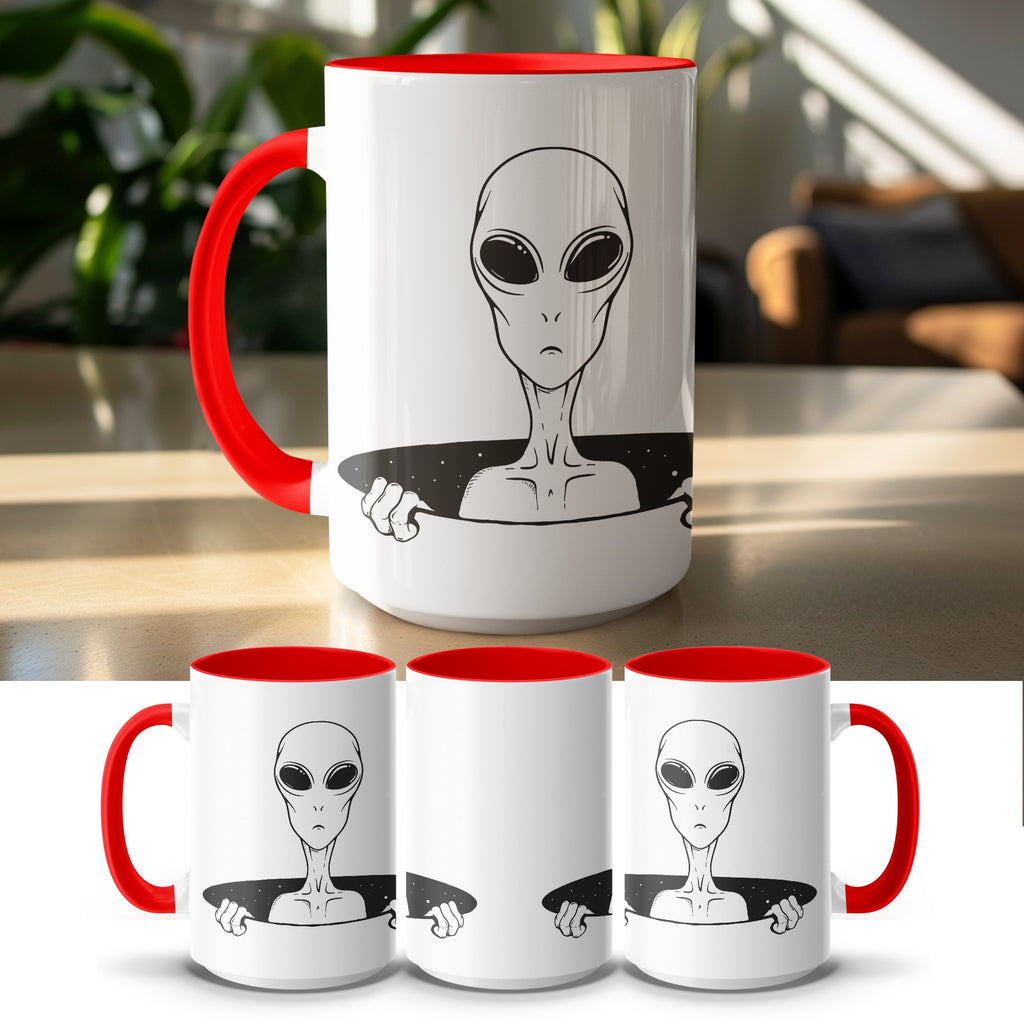 White mug with red interior and handle featuring a black alien design.