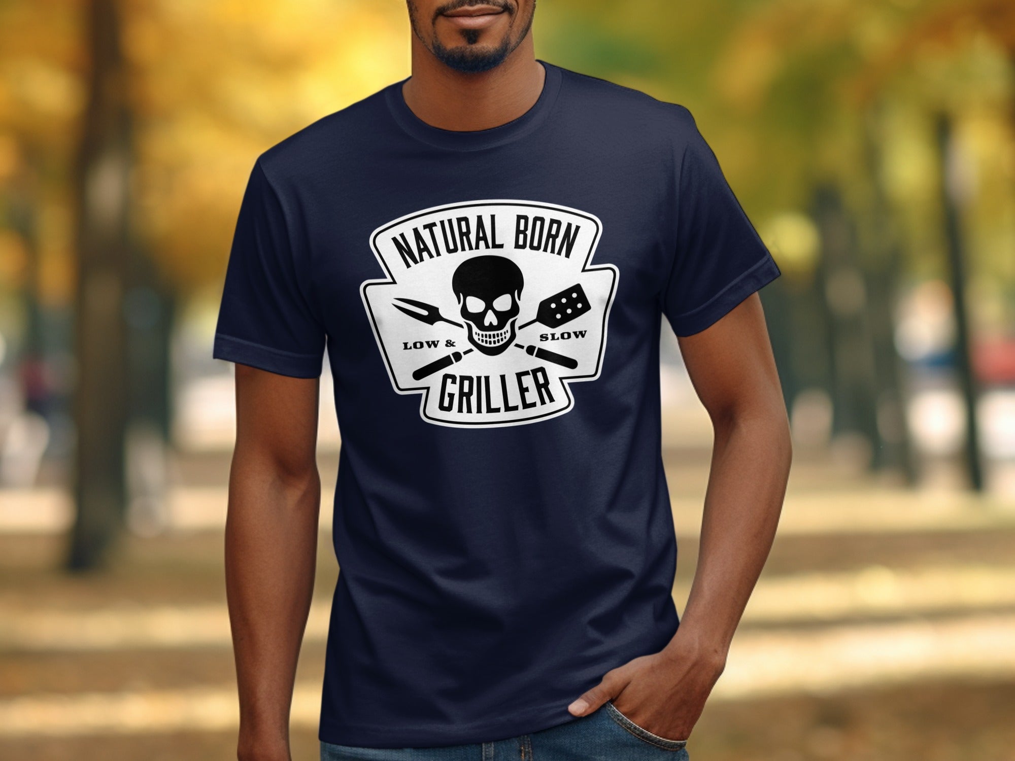 Navy t-shirt with "Natural Born Griller" skull logo and grilling tools.