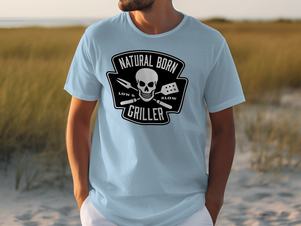 Light blue t-shirt with "Natural Born Griller" skull and grill tool design.