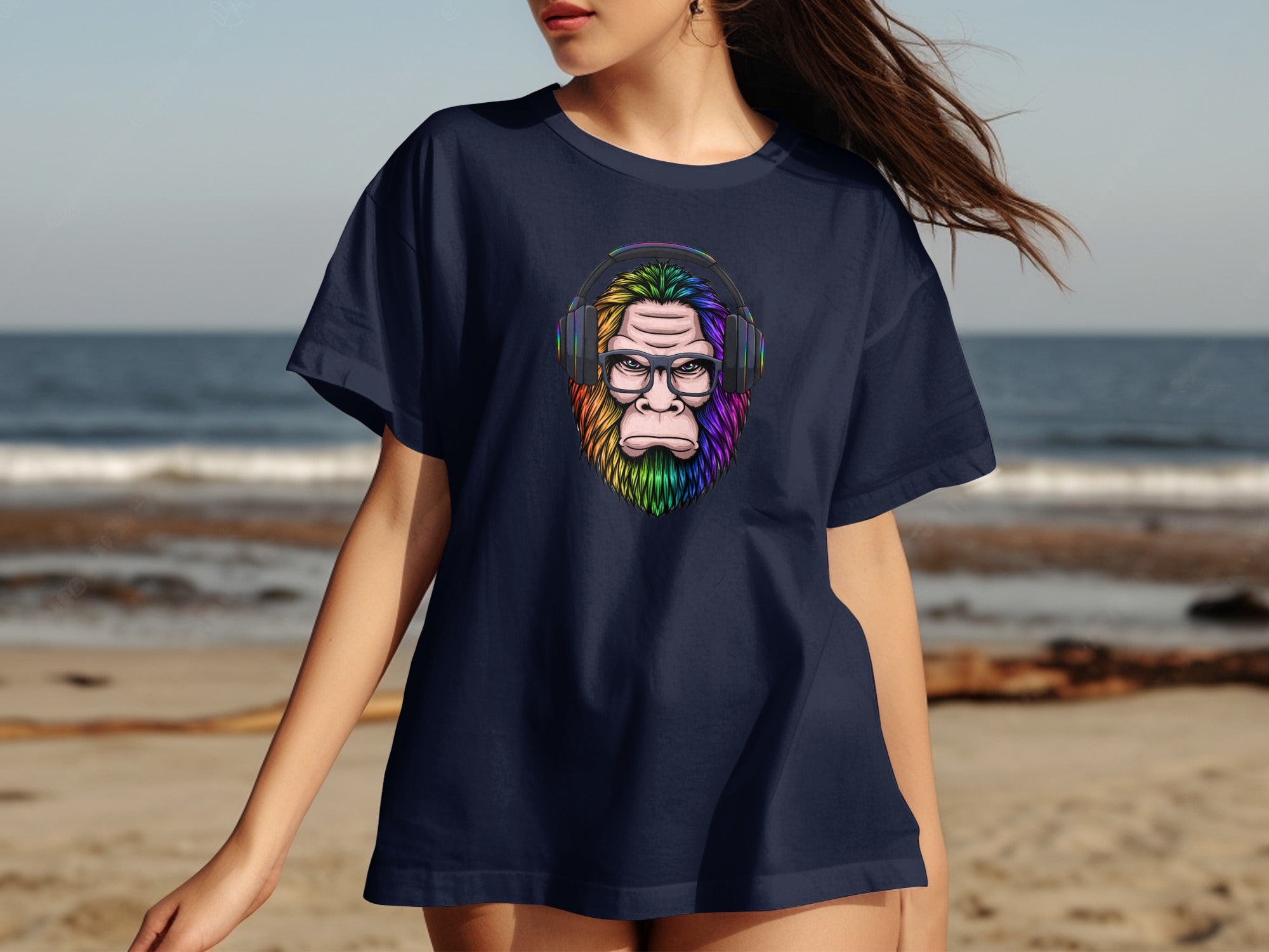 Dark blue t-shirt featuring a rainbow-colored Bigfoot with headphones and glasses.