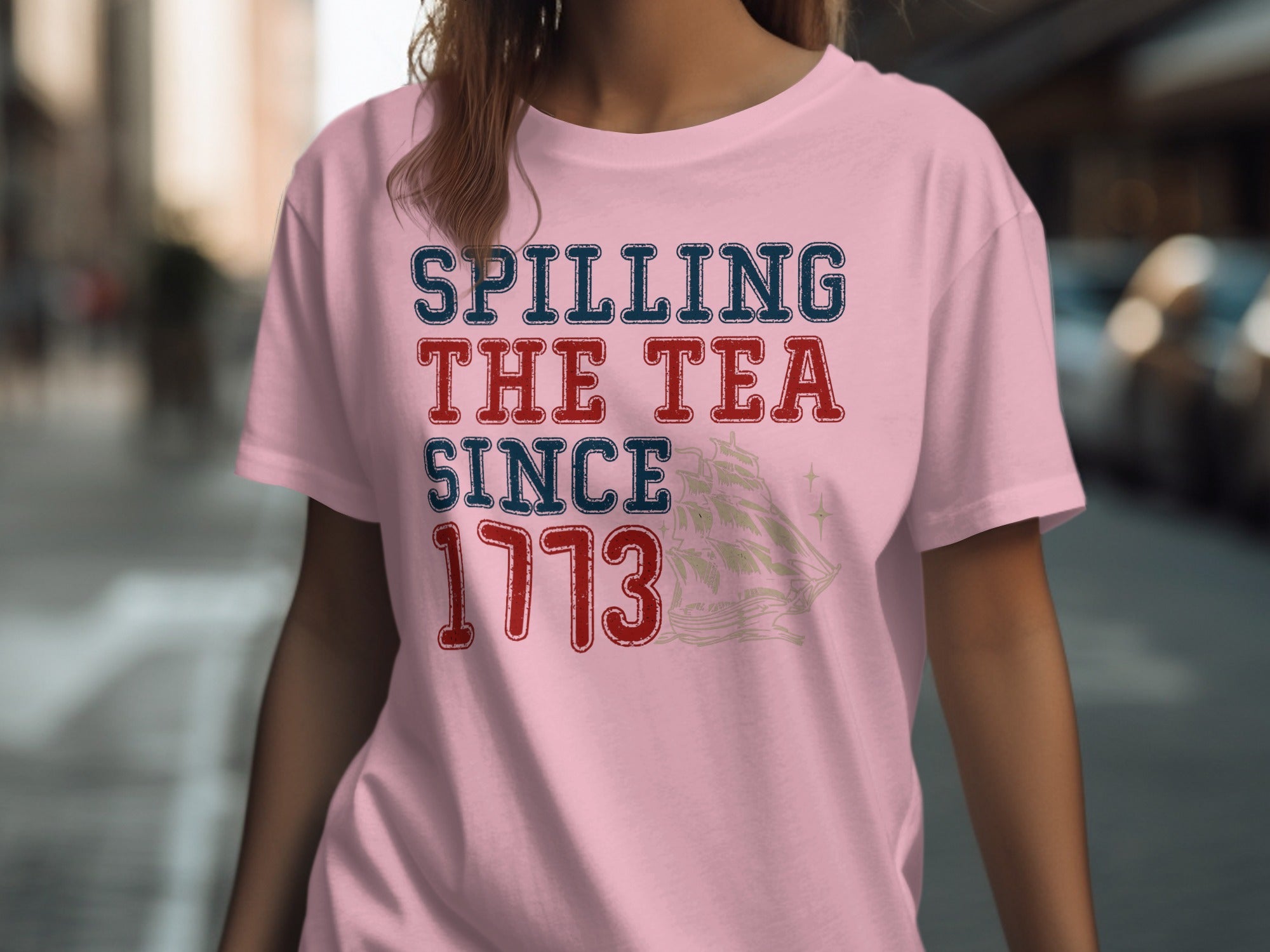 Pink t-shirt with text "Spilling The Tea Since 1773" and a ship graphic.