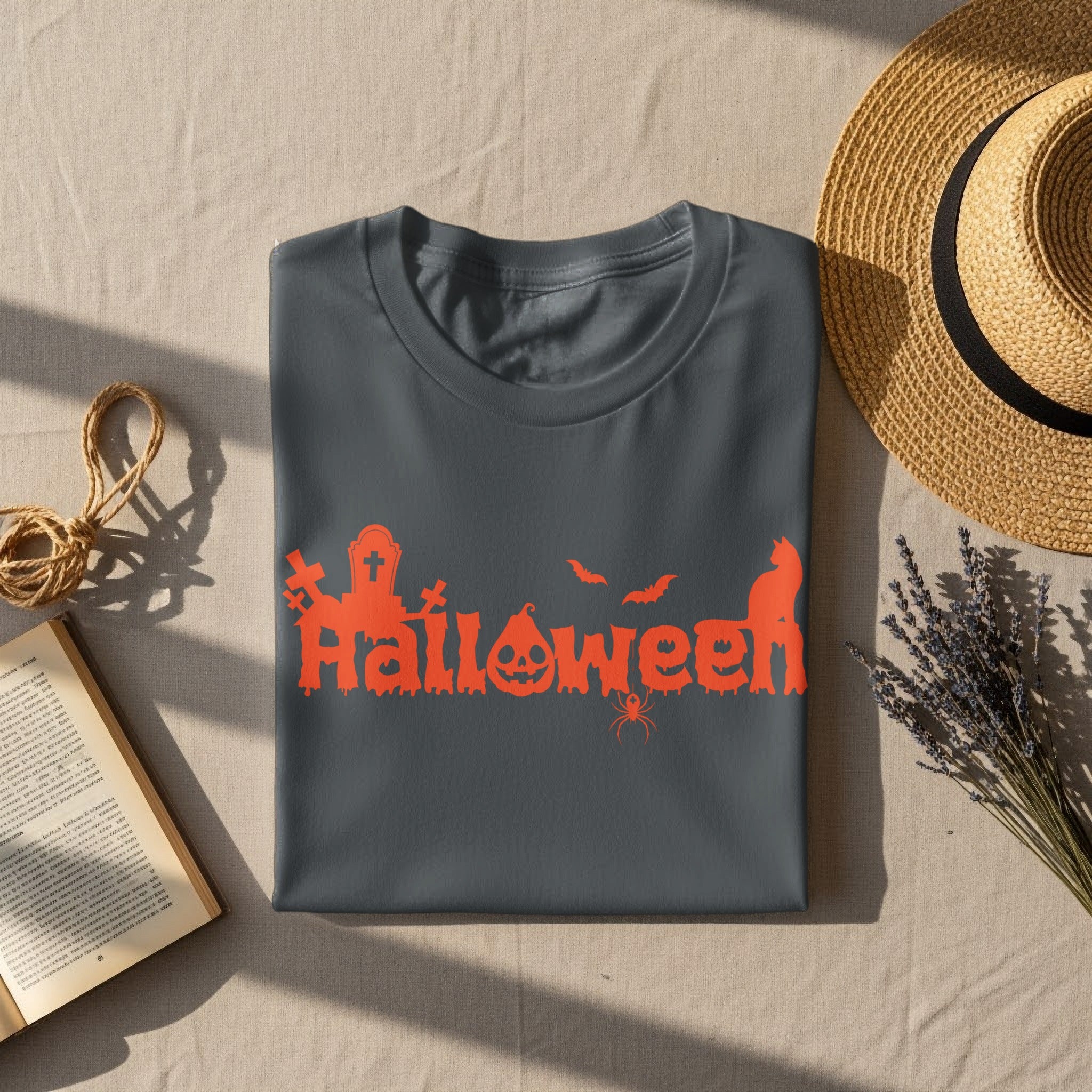Gray t-shirt with orange Halloween graphic featuring gravestones, pumpkin, bats, spider, and cat.