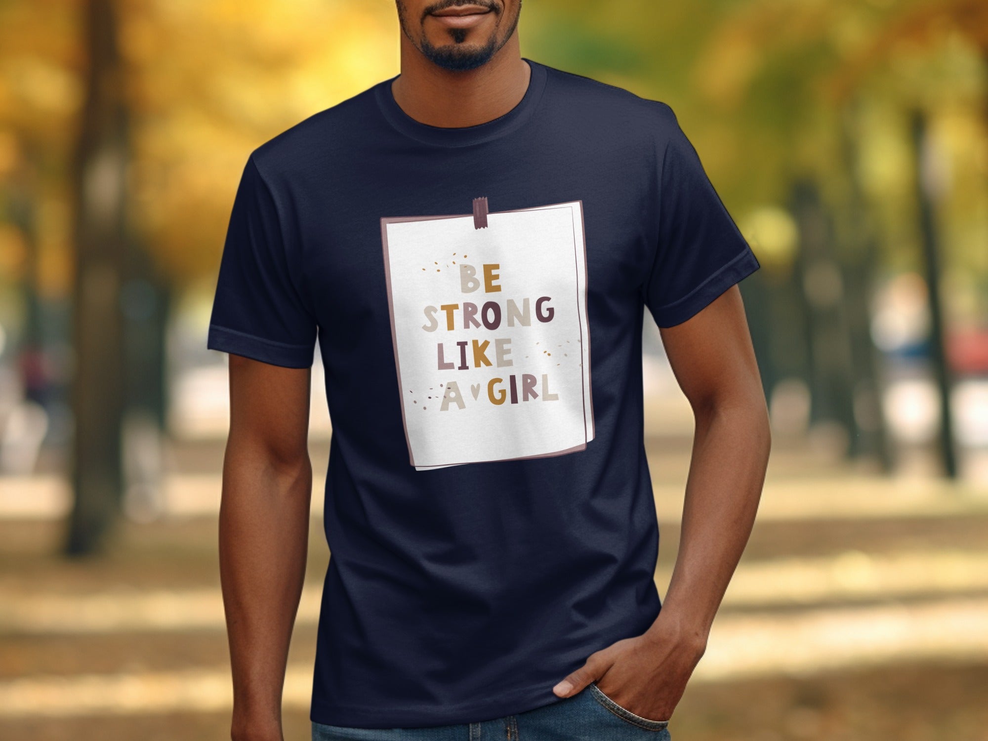 Navy t-shirt with text "BE STRONG LIKE A GIRL" on a white background.