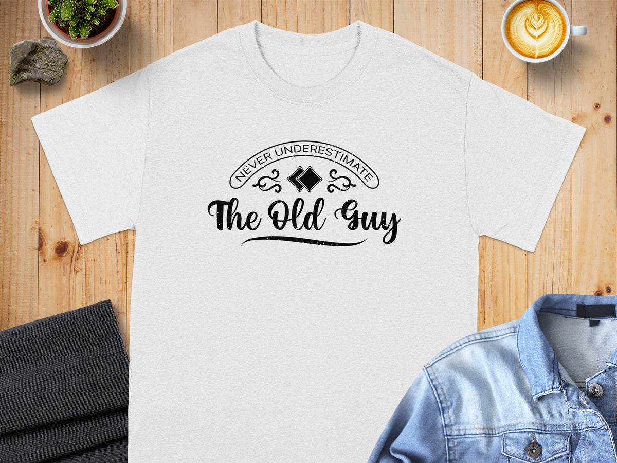 White t-shirt with "Never Underestimate The Old Guy" text.