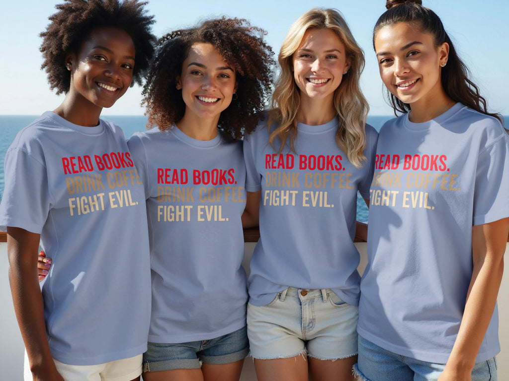 Four smiling women wear light blue t-shirts with "Read Books. Drink Coffee. Fight Evil." slogan.