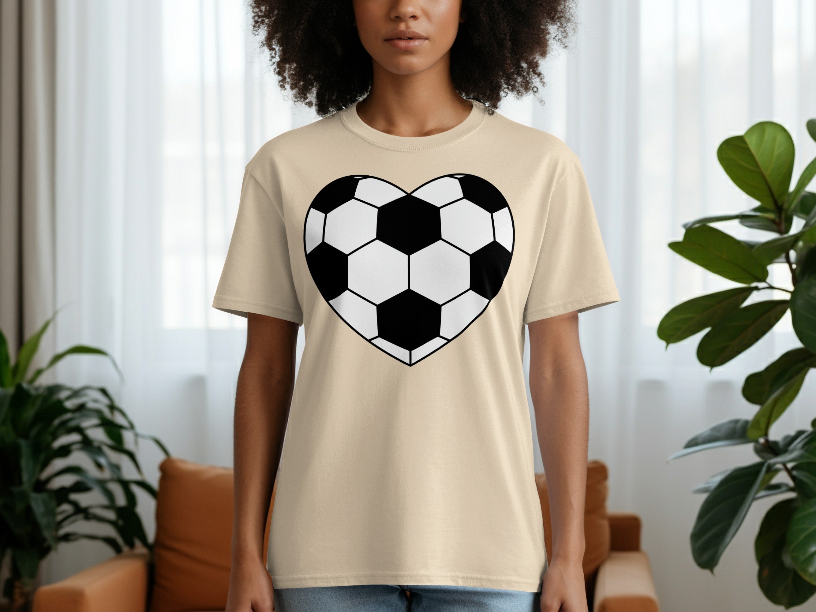 Beige t-shirt with a black and white heart-shaped soccer ball graphic on the chest.