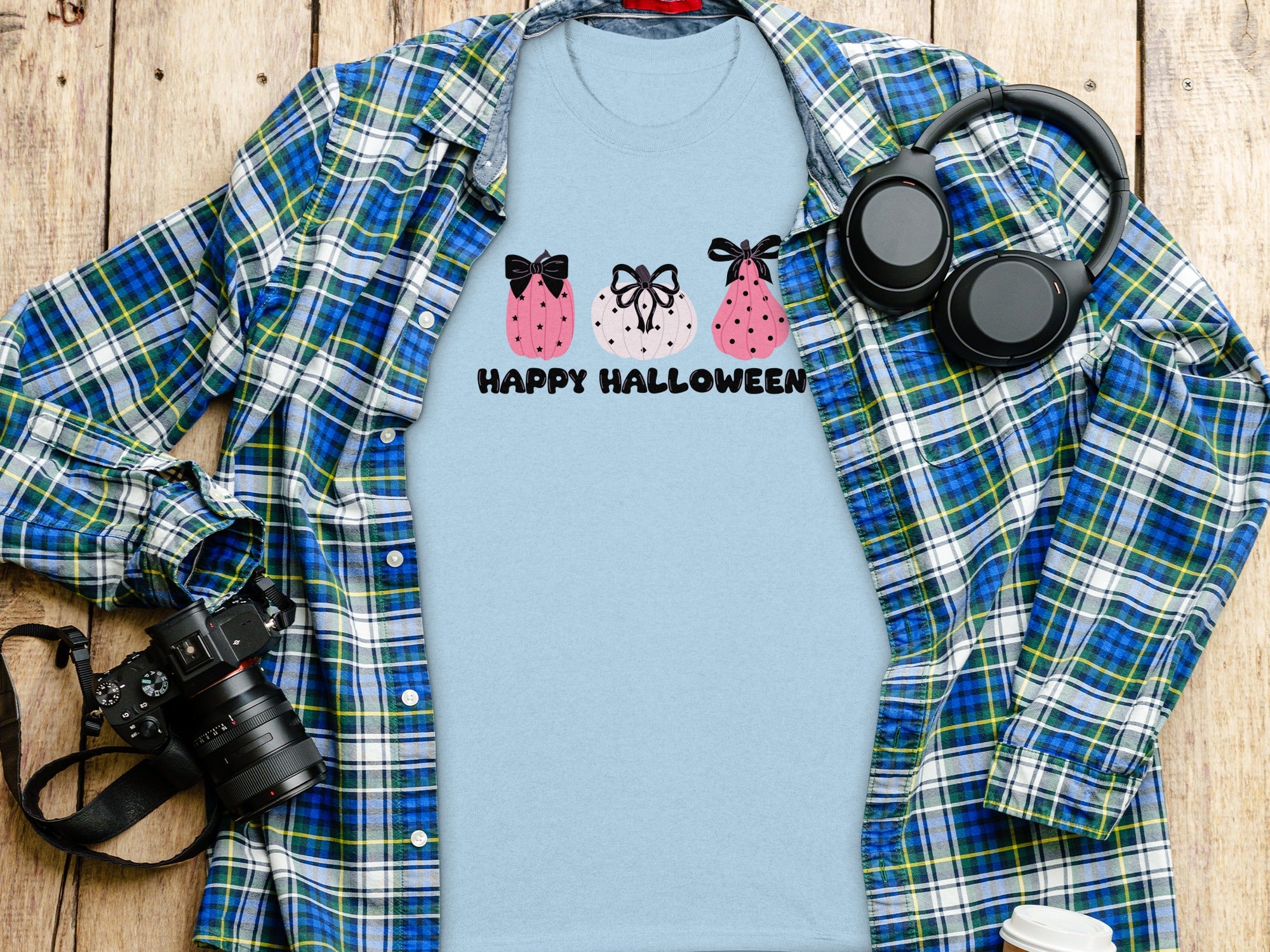 Light blue t-shirt with pumpkins and "Happy Halloween" text.