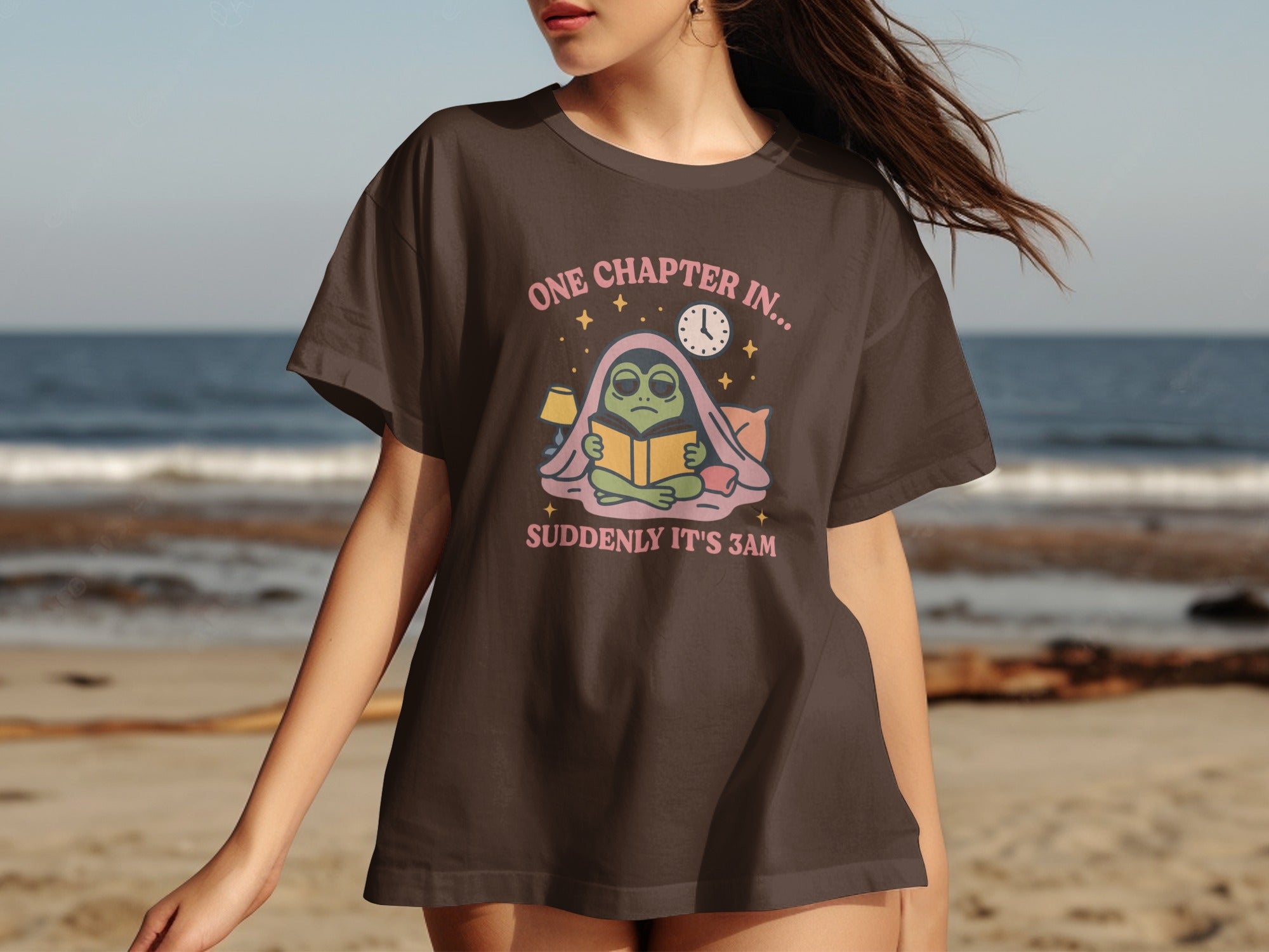 Brown t-shirt with alien reading a book, "ONE CHAPTER IN... SUDDENLY IT'S 3AM".