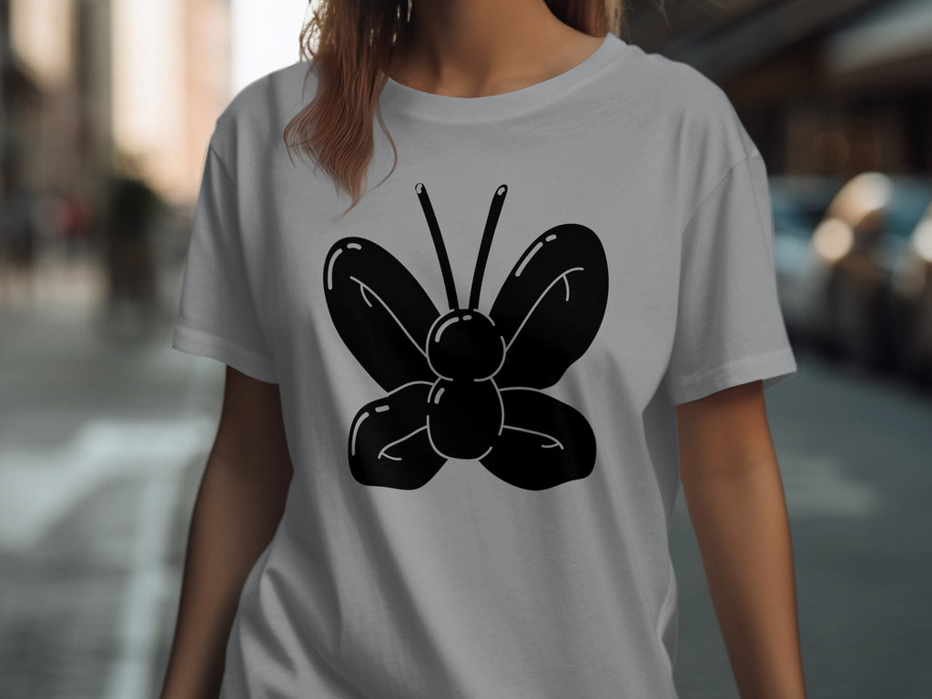 Black butterfly graphic on a light gray t-shirt.