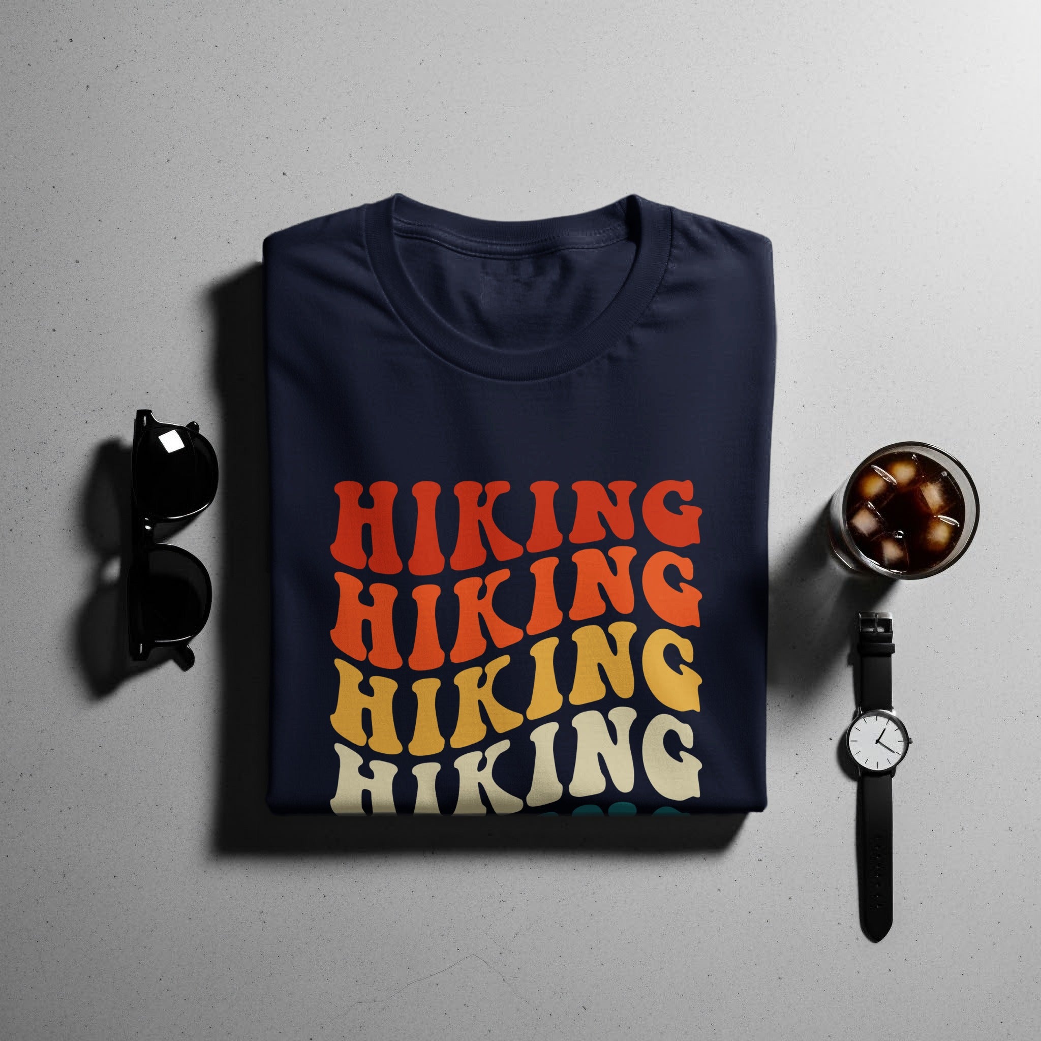 Navy t-shirt with retro "HIKING" text in multiple colors.