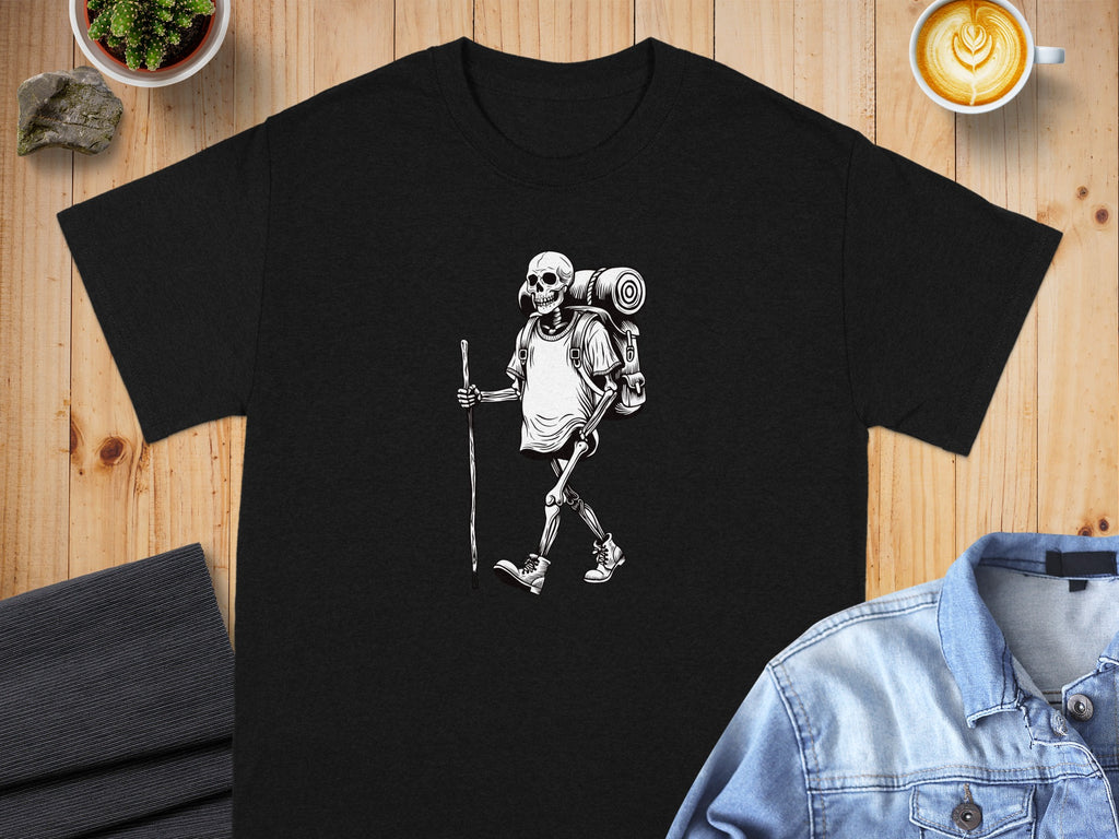 Black t-shirt with a black and white illustration of a skeleton hiker with a backpack.