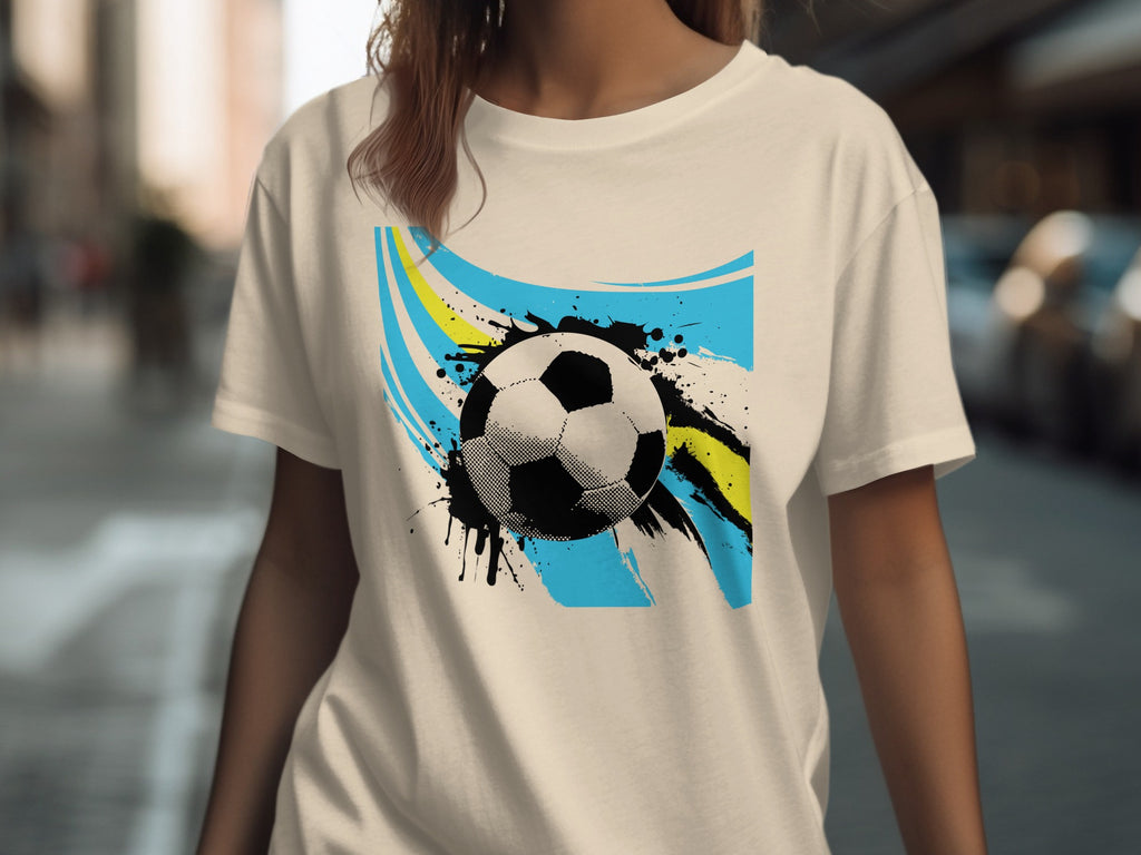 T-shirt with abstract soccer ball design featuring blue and yellow brush strokes.