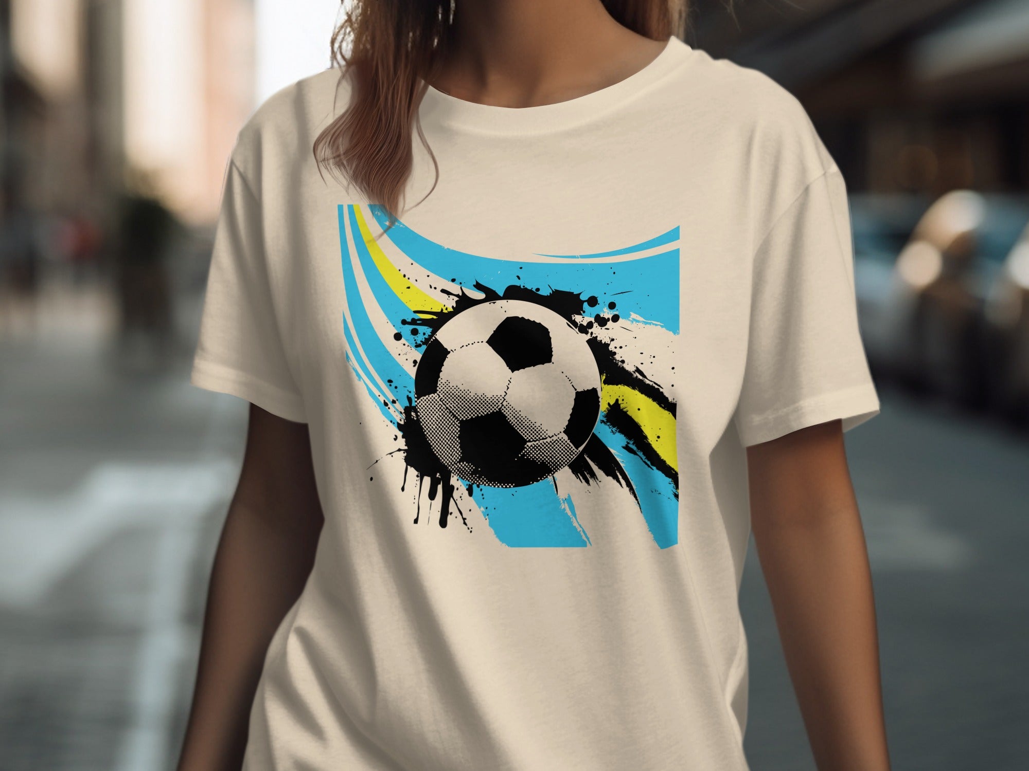 T-shirt with abstract soccer ball design featuring blue and yellow brush strokes.