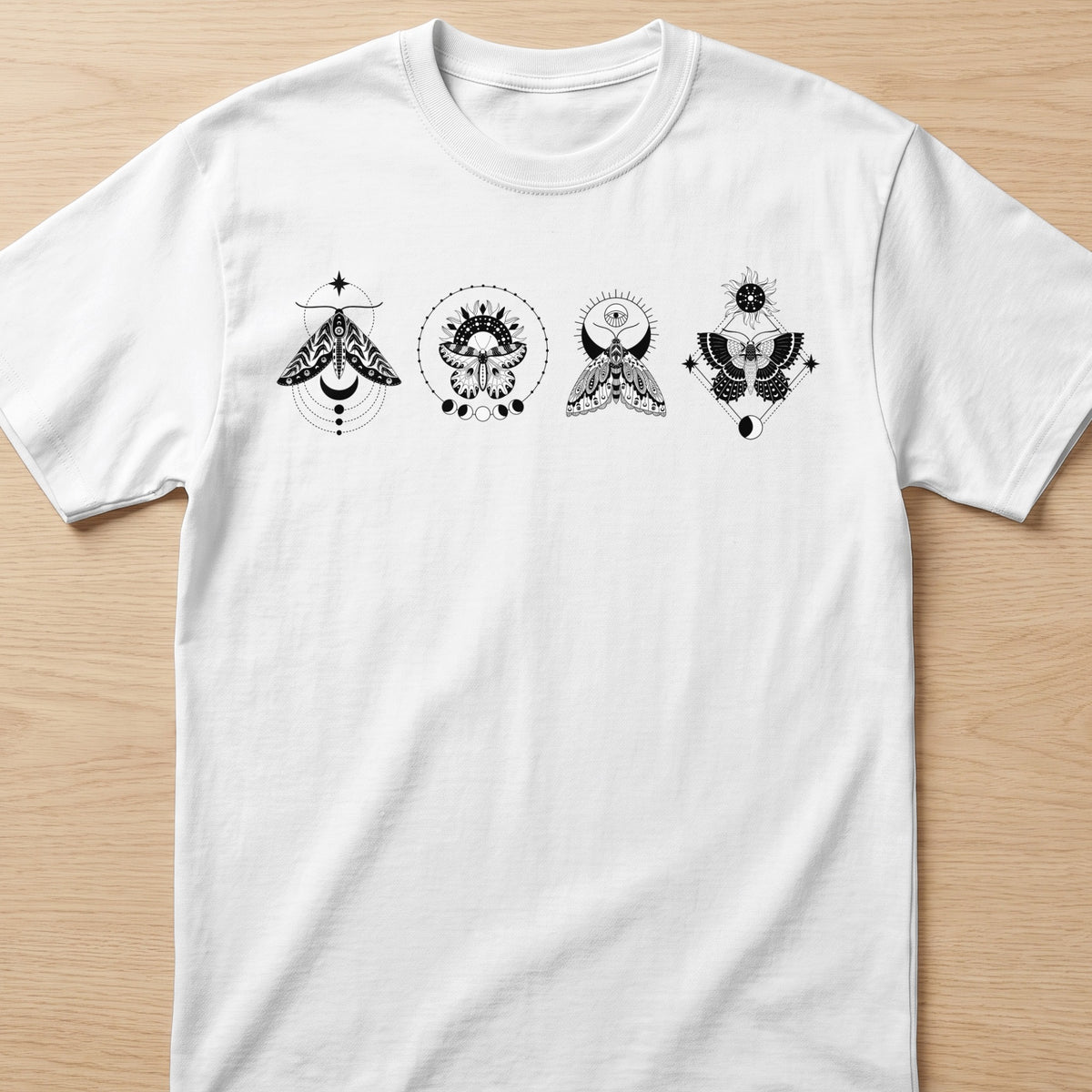 White t-shirt with black moth and celestial graphic designs.