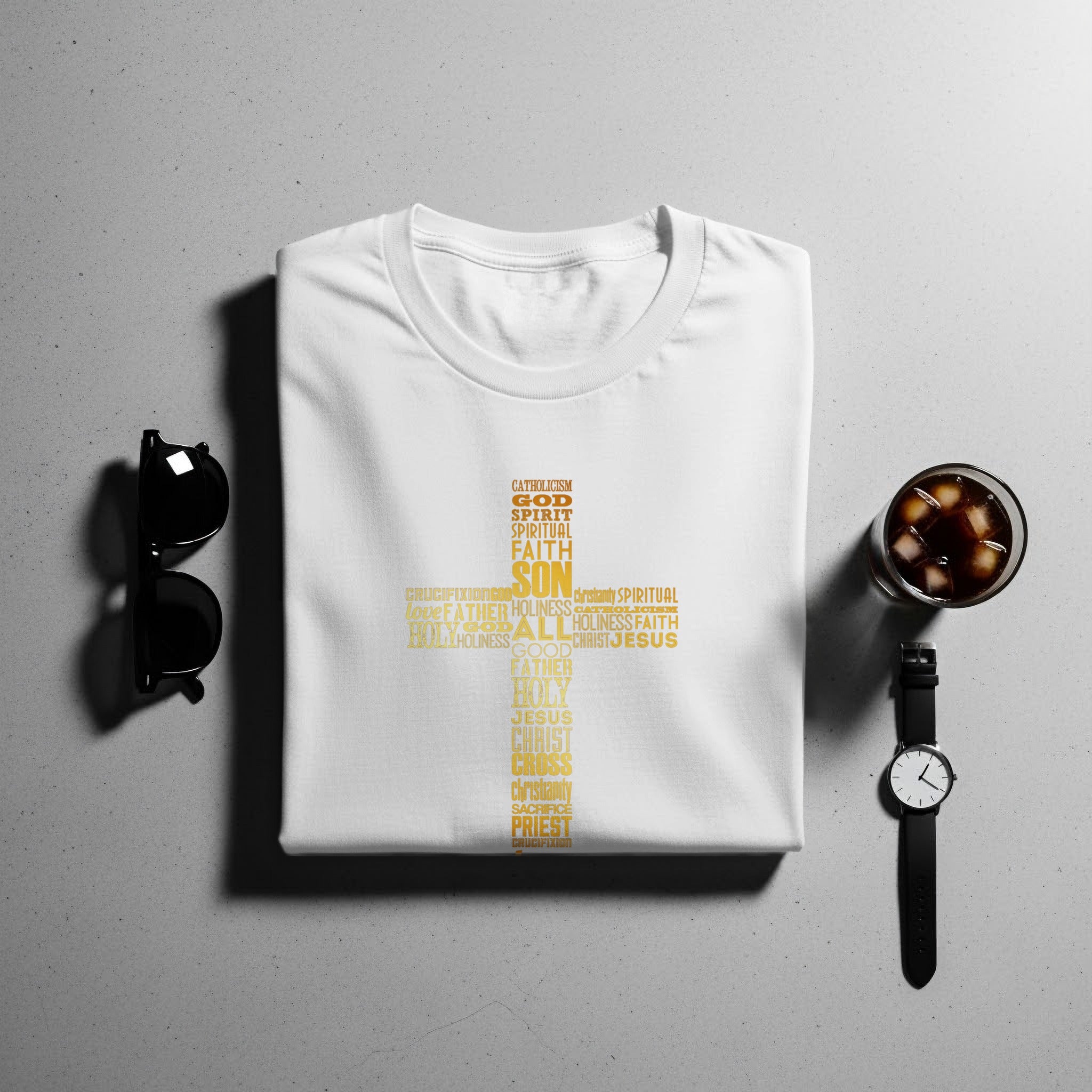 White t-shirt with gold religious word art forming a cross.