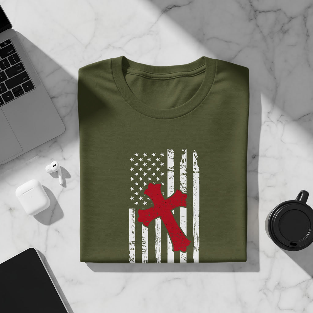 Olive green t-shirt with distressed American flag and red cross graphic.