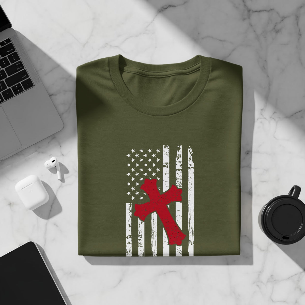 Olive green t-shirt with distressed American flag and red cross graphic.